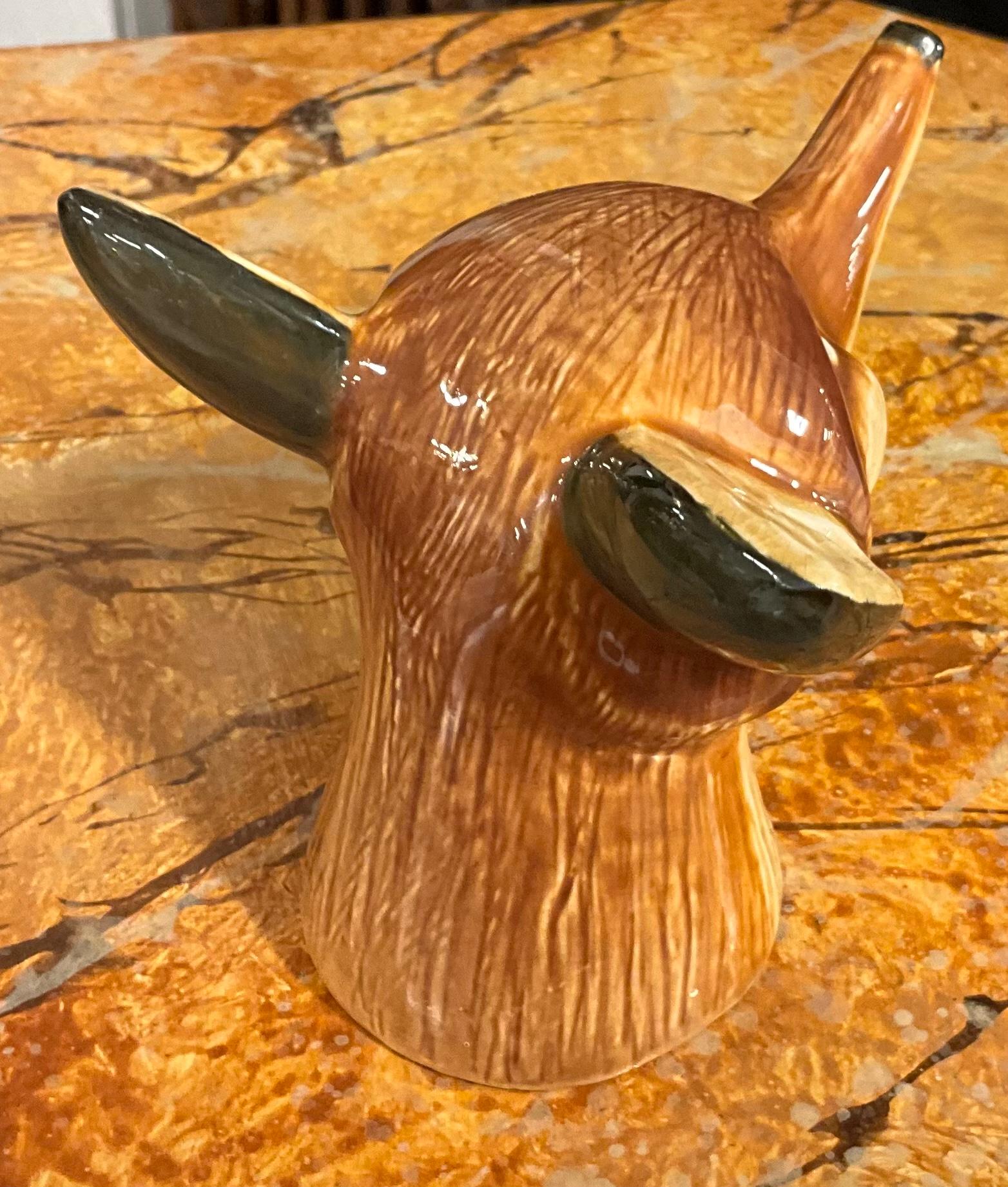 A little rare stirrup cup! I have had many, but not like this little guy.! It is a late 19th century English staffordshire pottery stirrup cup. It is in the form of a fox head. There are no condition issues to note.