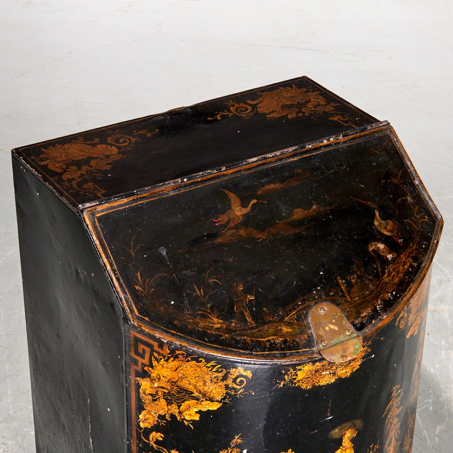 A charming and atmospheric 19th-century English tole coal bin or scuttle, beautifully decorated in the chinoiserie style, with hand-painted gilt figures in a landscape on a black ground. The front panel features two robed figures in an exotic garden