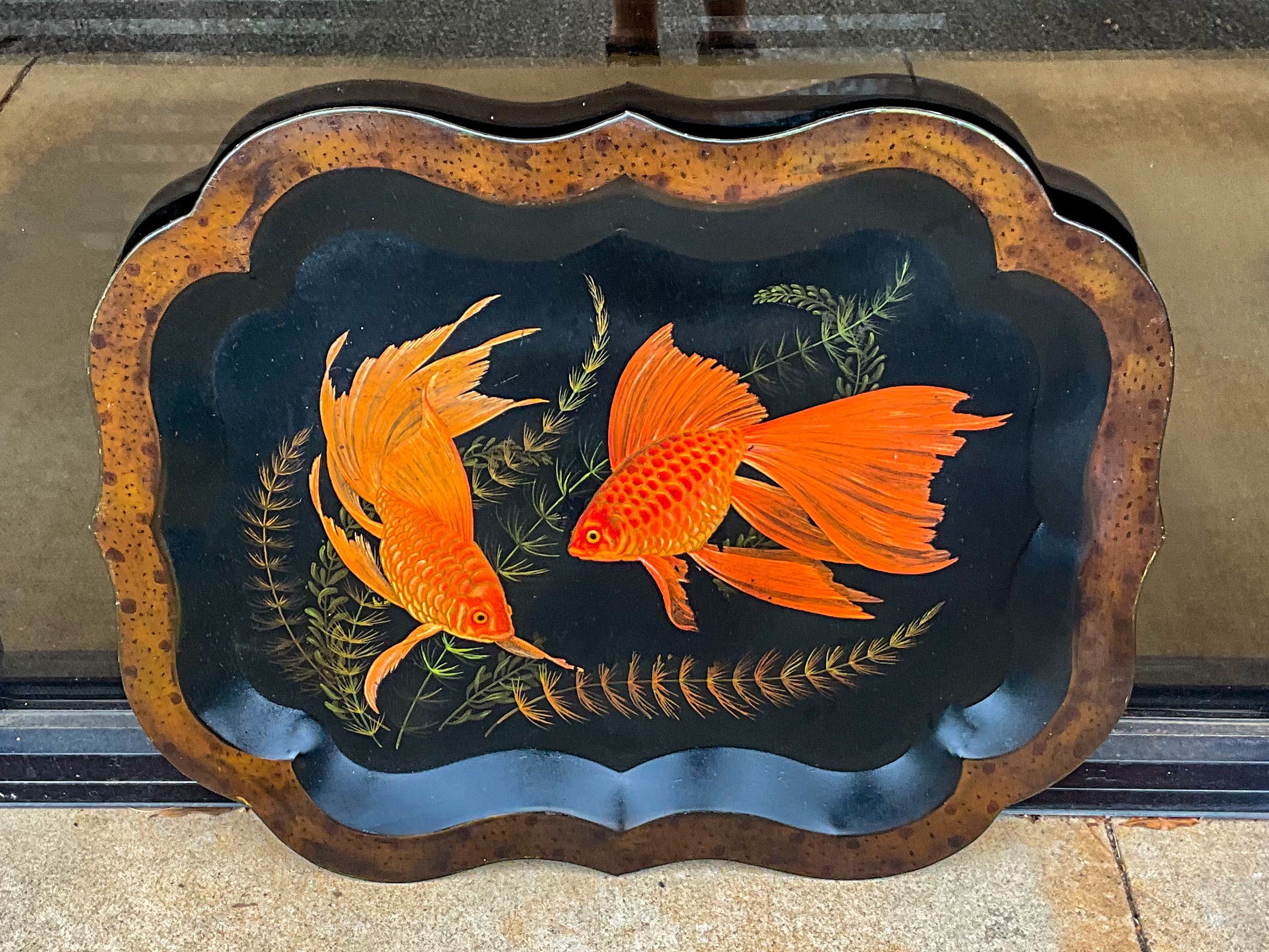This is a lovely early English black toleware tray. I believe the faux tortoise paint along the rim along with the two carp and sealift are vintage additions. The tray does show same age appropriate wear that does not detract from it’s beauty.