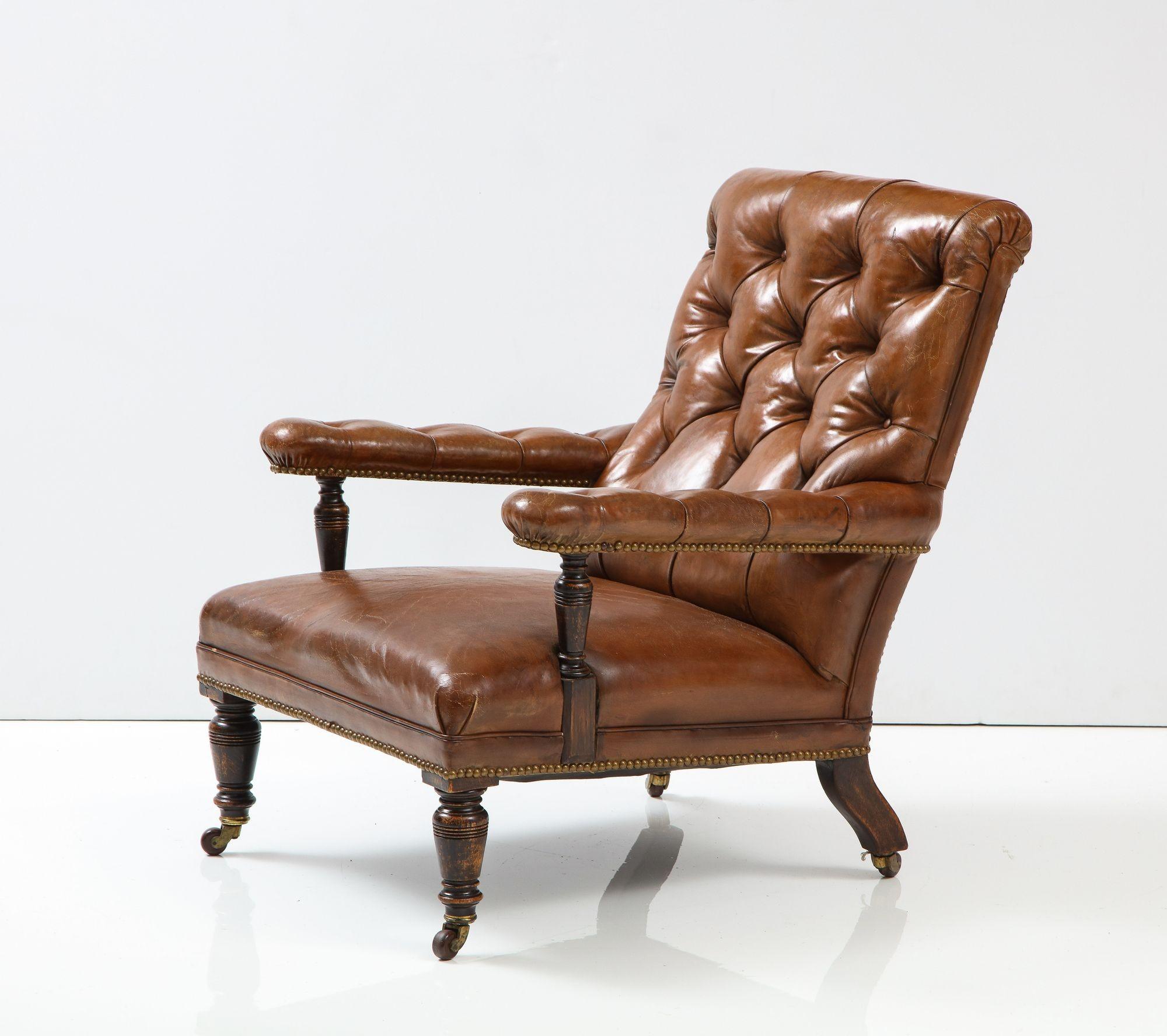Good 19th c. English club chair in tobacco brown leather, the tufted back with easy pitch and having open arms with turned supports, over leather seat with turned legs and original brass castors, the whole with good color and patina.
 
Dimensions:
