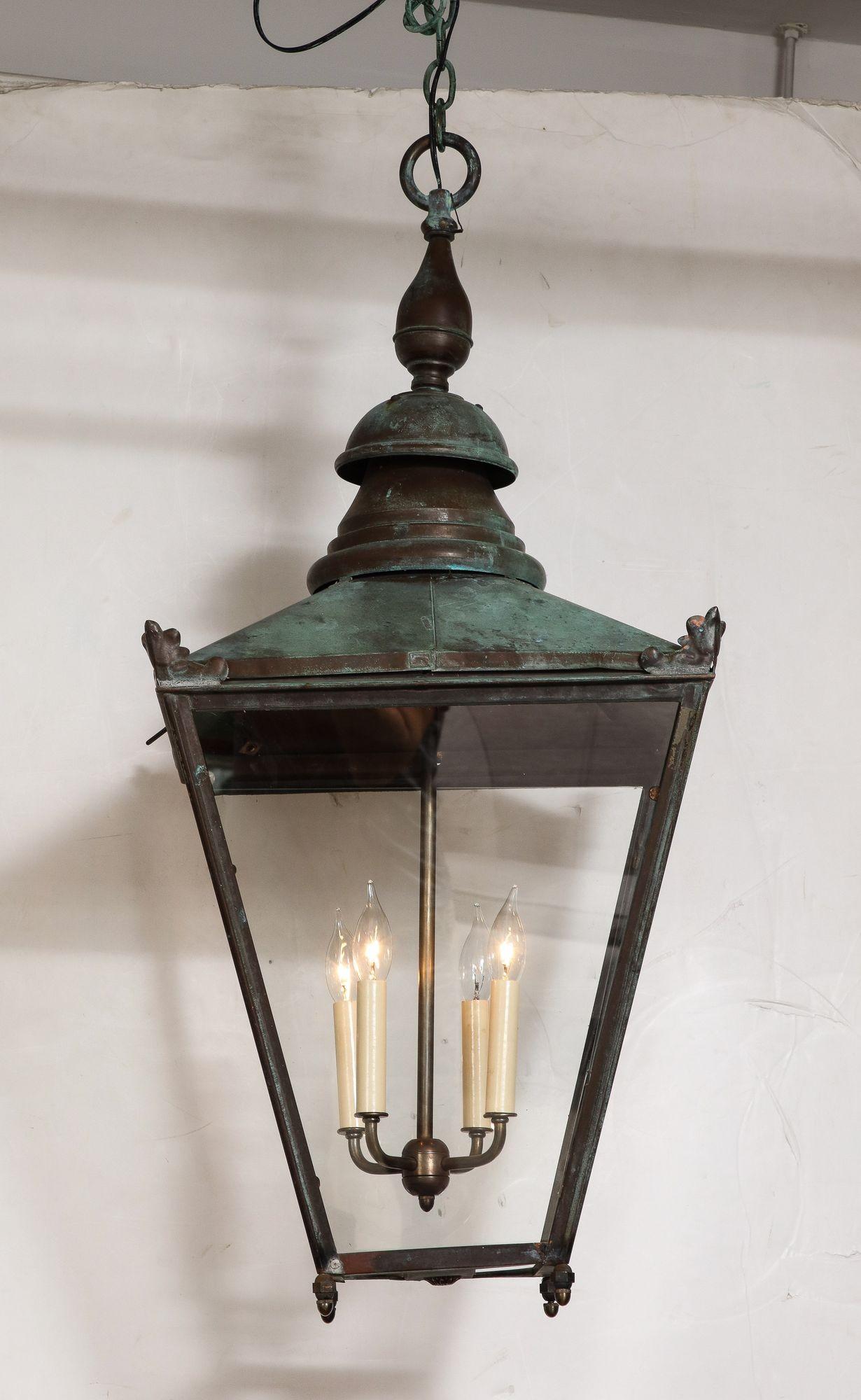 English 19th century copper hall lantern, now electrified, with wonderful natural verdigris surface, having tapered form, the corners with palmette details, with four light fixture. 