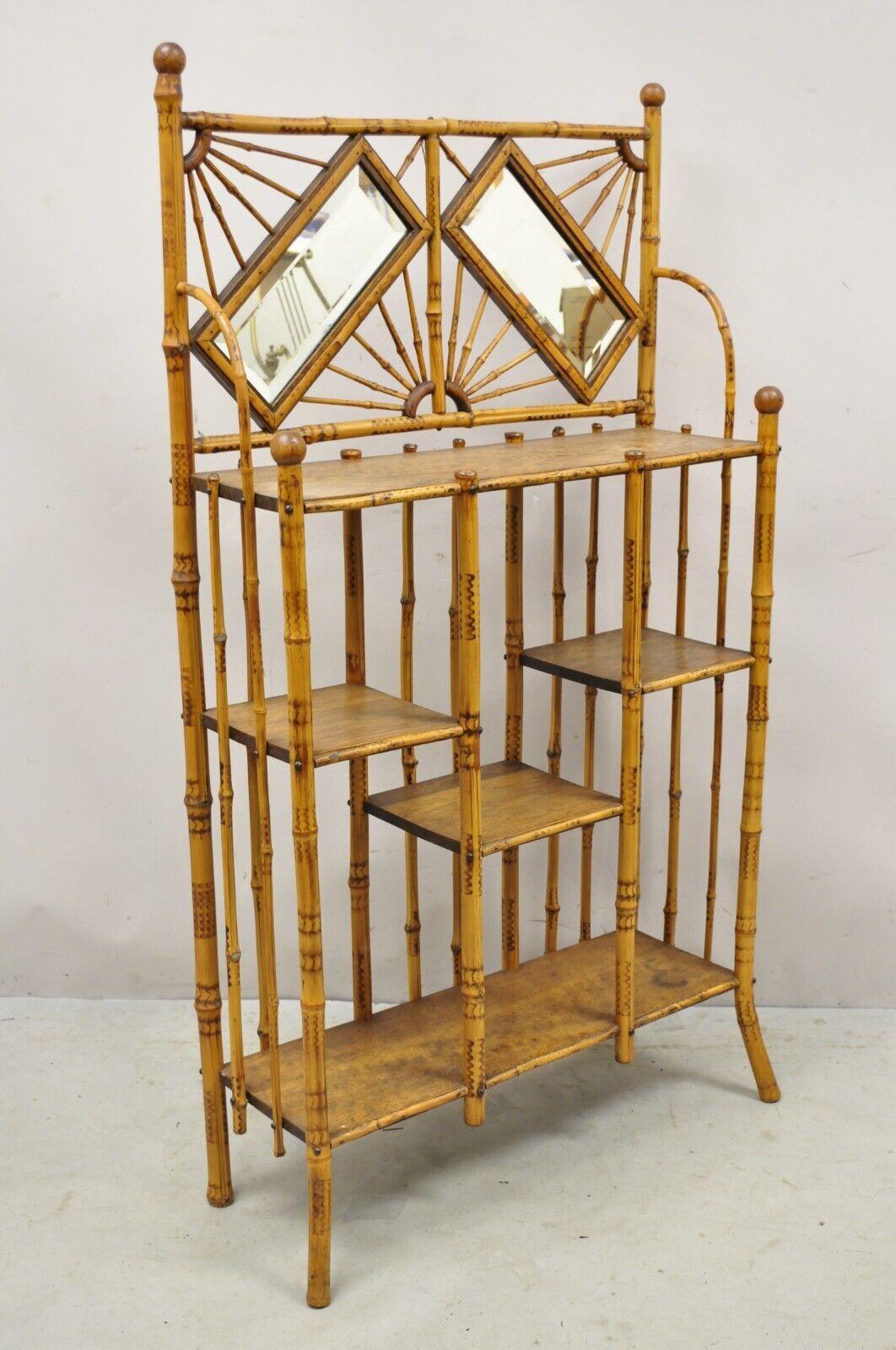 19th Century English Victorian Bamboo Stick and Ball Curio Shelf Display Etagere w/ Mirror. Item features 2 beveled glass mirrors, bamboo wood construction, ornate fretwork stick and ball design, 5 wooden shelves, very nice antique item, quality