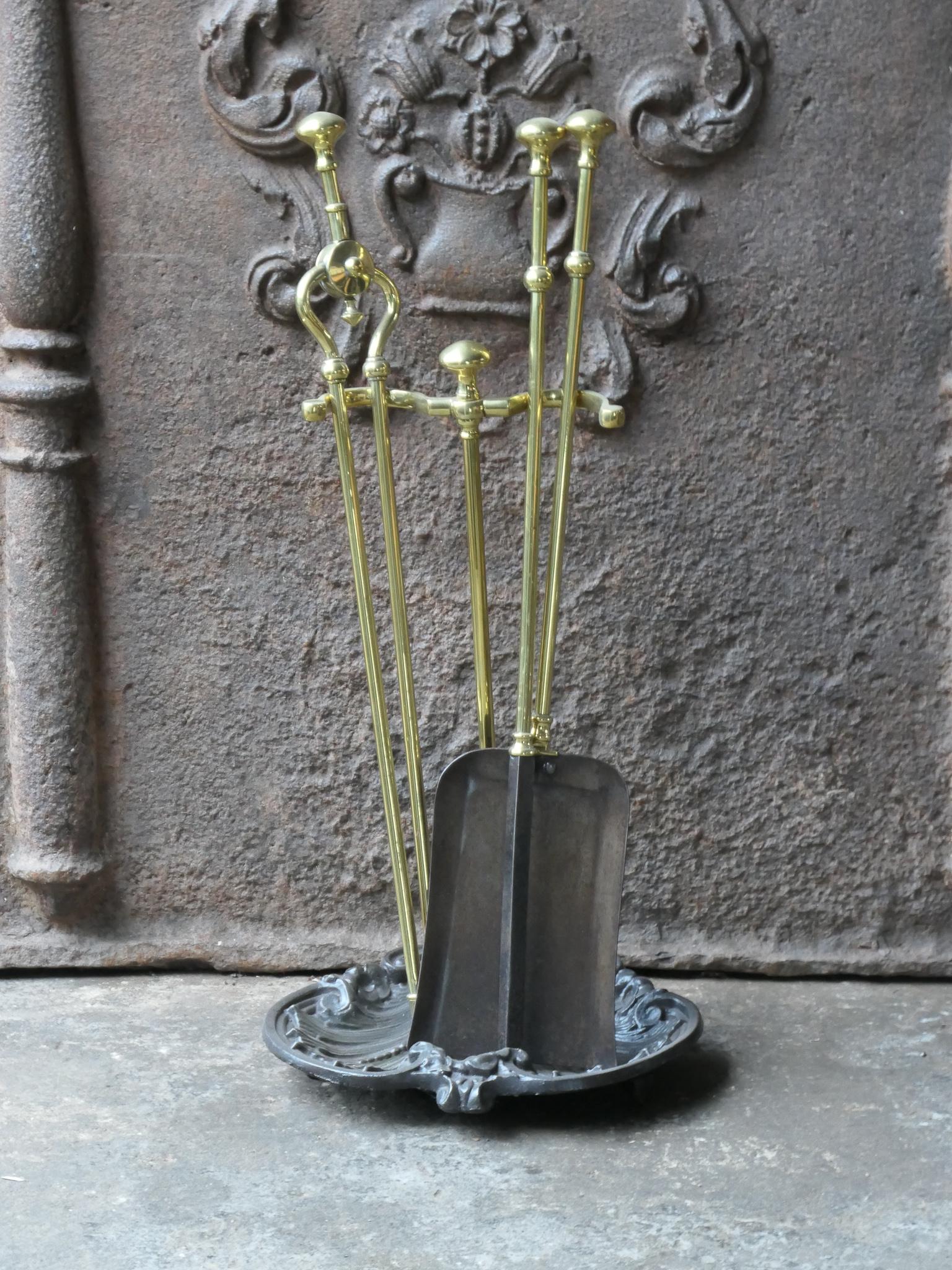 19th Century English Victorian fireplace tool set. The tool set consists of tongs, poker, shovel and stand. The set is made of brass and cast iron. The set is in a good condition and fit for use in the fireplace.