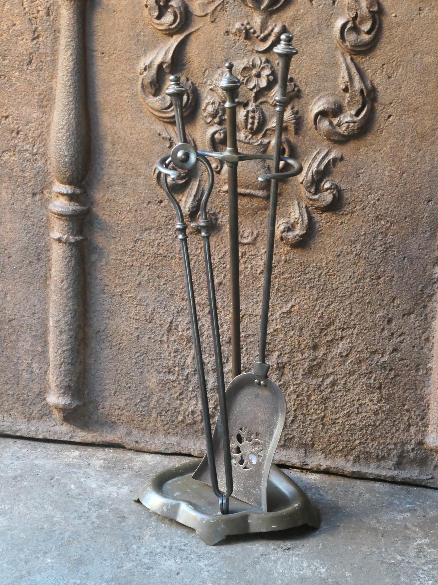 19th century English Victorian fire companion set. The tool set consists of thongs and shovel and stand. Made of wrought iron and brass. It is in a good condition and is fully functional.