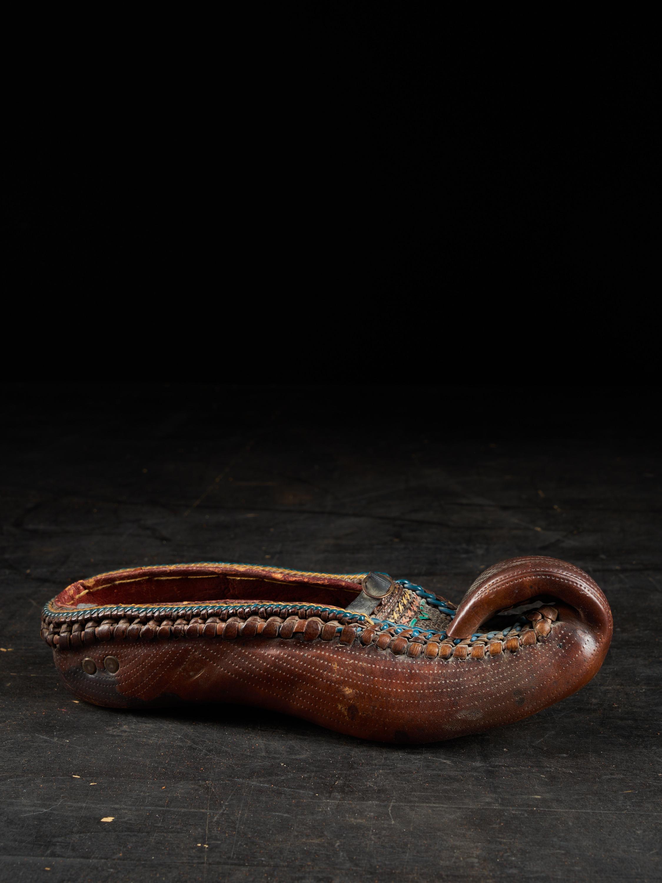 Beautiful leather shoe from Eastern Europe tracing back to the 19th century. This vintage item features delicate and detailed patterns. A beautiful item steeped in history that will delight collectors.