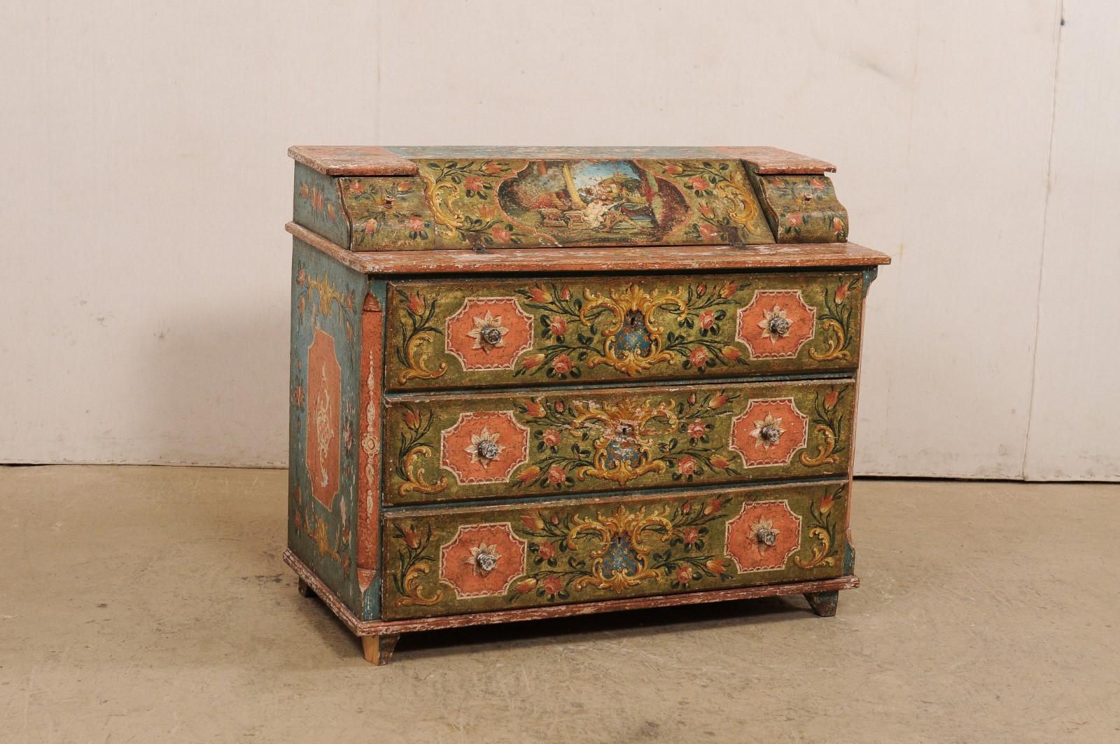 A European wooden secretary chest, with original hand-painted finish, from the 19th century. This antique chest from Europe features a slanted fall-front at top, flanked between two small pull-out drawers, which opens to reveal open storage within a