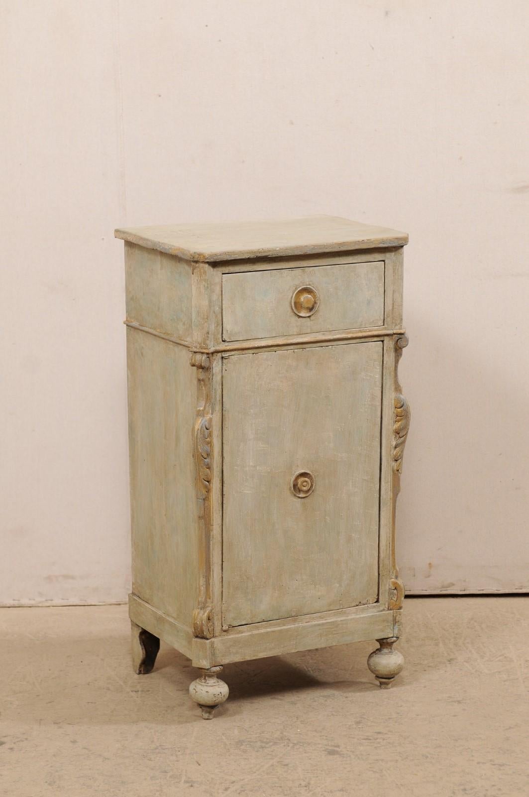A small-sized Central European painted wood cabinet with single drawer and door from the 19th century. This sweet little cabinet from Central Europe is fitted with a small-sized single drawer within it's apron, resting just above a single door which
