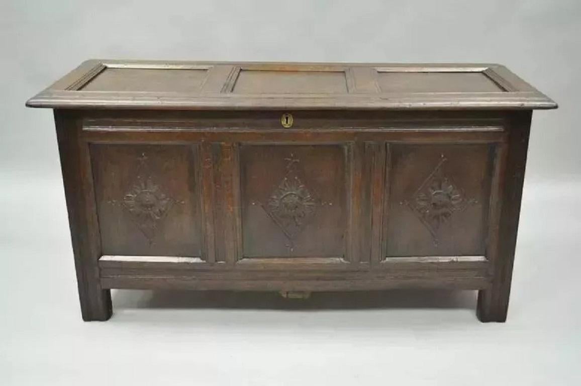 19th C. Three Panel Hand Carved Solid Oak European Coffer Blanket Chest Trunk. Item features a solid carved oak wood frame with exposed dowel or wooden pin joined construction. The front features three hand-carved panels as well as paneled sides and