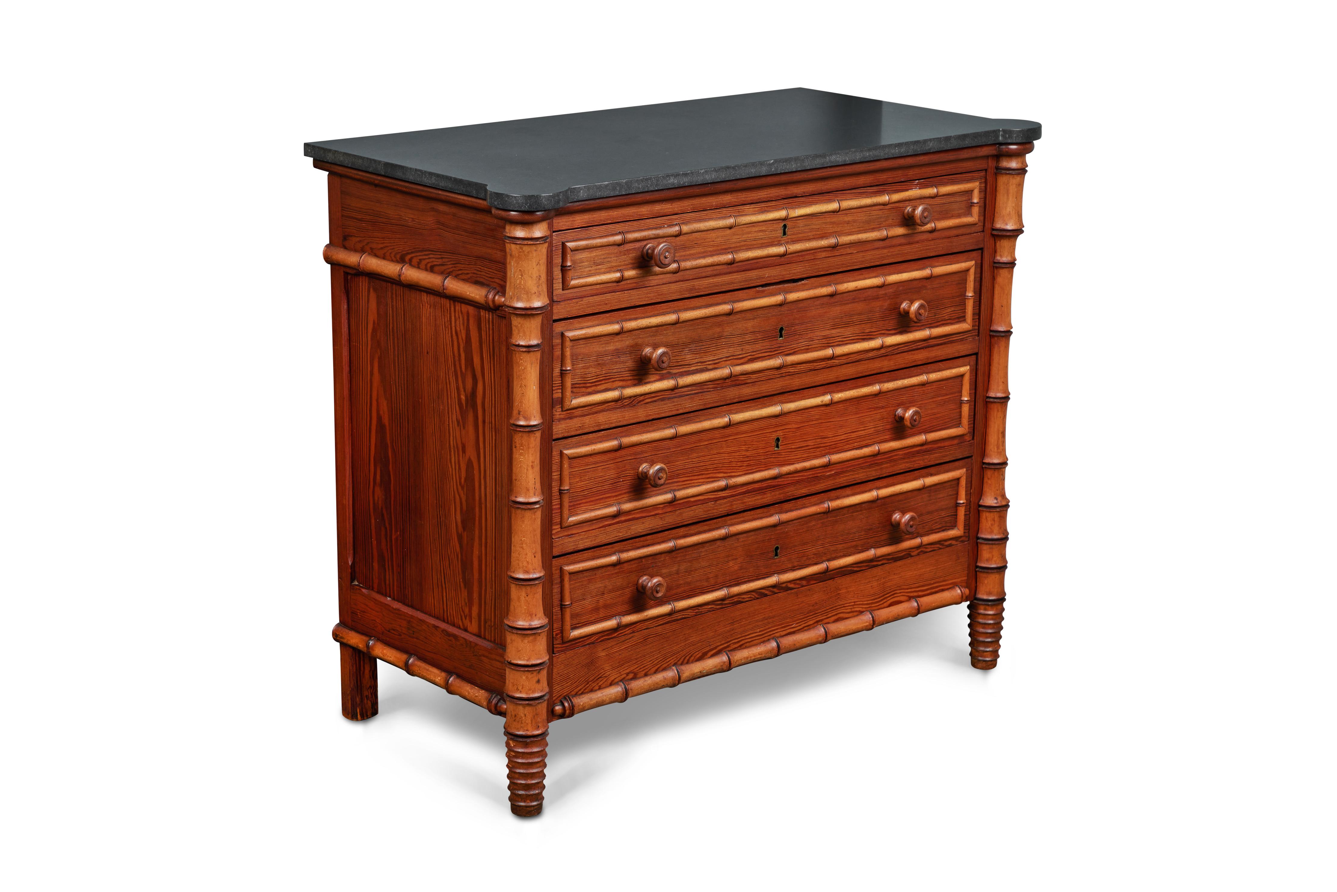 This fantastic 4 drawer pine chest was crafted with faux bamboo decorative mouldings and columns.

It is accented by a removable piece of rich complimentary honed black granite. This example of faux bamboo decoration was a style statement during