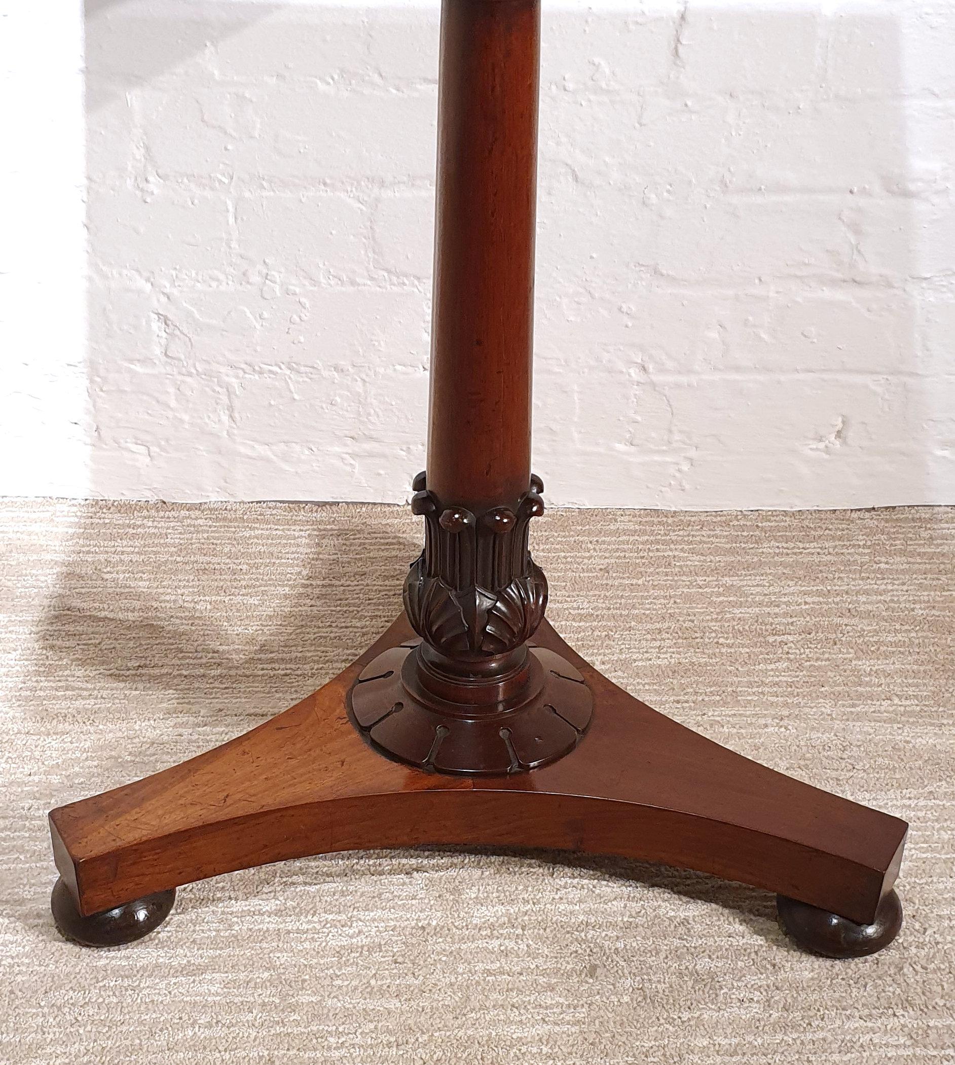 This lovely and petite sized flame mahogany side table swivels and opens up to reveal a games table. The inside has a green baize surface with a shallow storage compartment to store games pieces and cards. It is supported on a central pedestal base