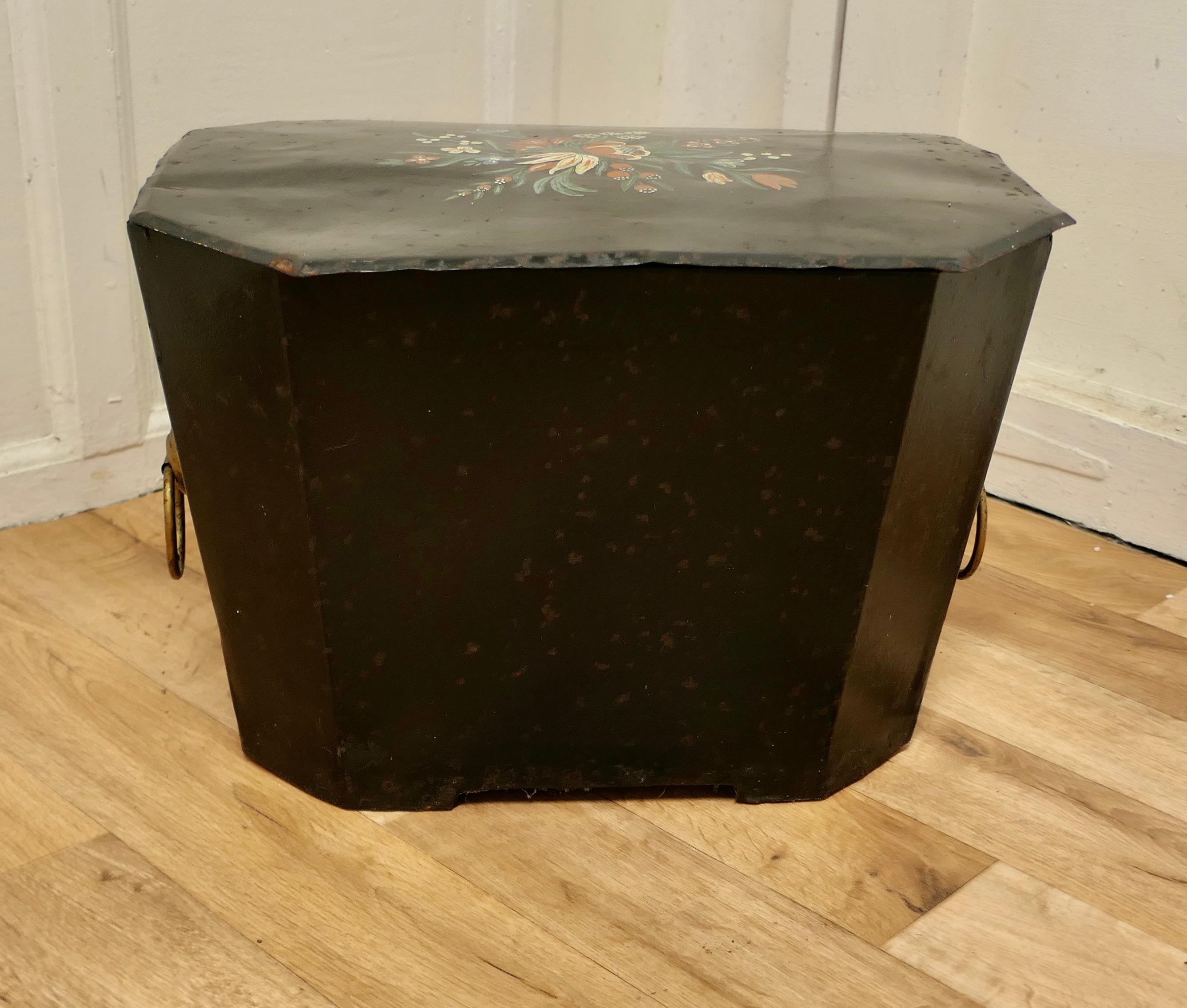 19th C folk art barge wear, Toleware log box

Delightfully decorated with flowers, this toleware box is rectangular with chamfered corners and decorated with Barge Wear Folk Art painting, it has solid wooden bottom and chunky ring handles