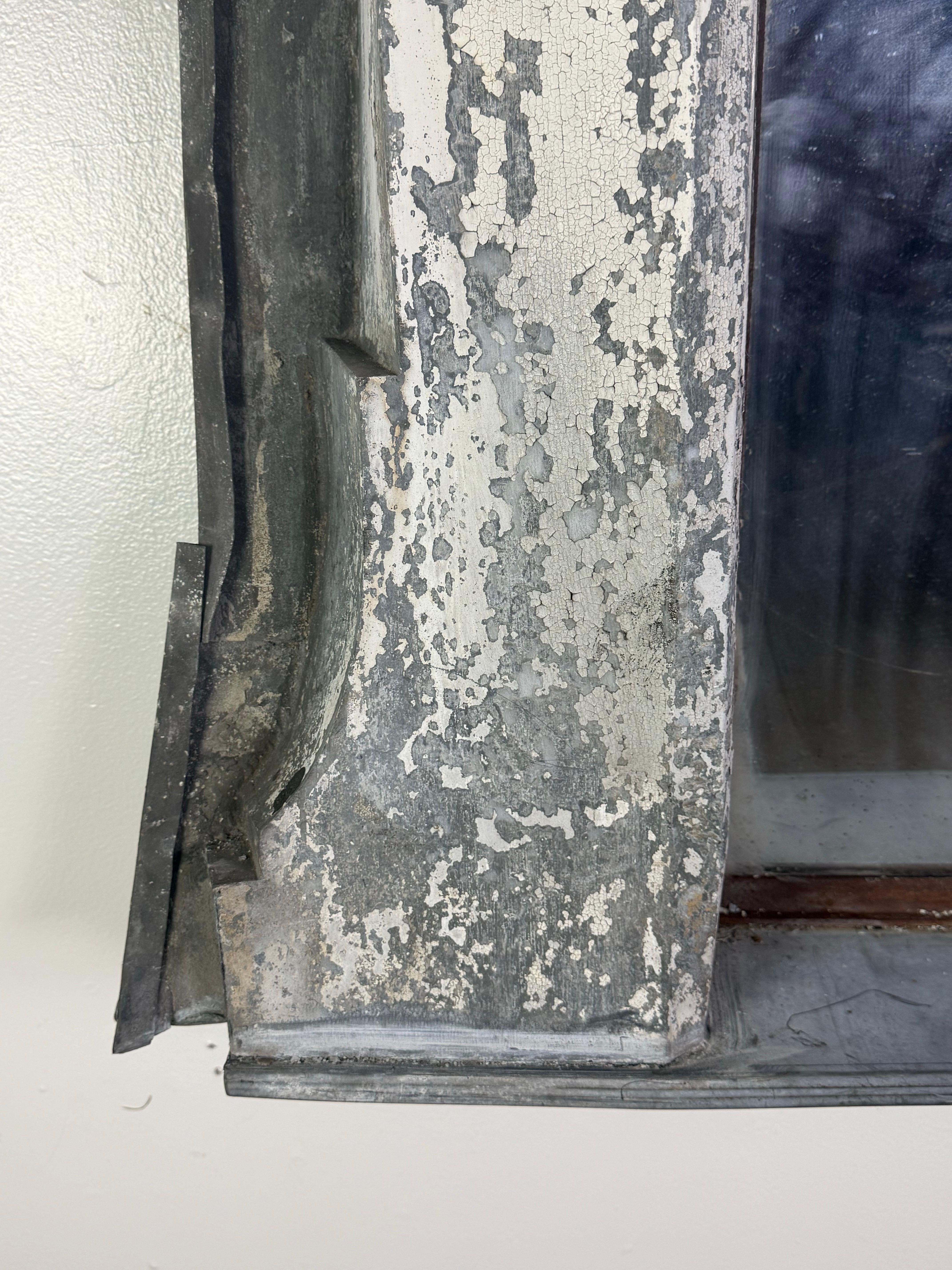 A striking architectural mirror fashioned from an antique dormer window frame, exuding authentic European charm and a deeply aged patina.

The frame, likely late 19th to early 20th century, is constructed of zinc or lead-coated metal, once part of a