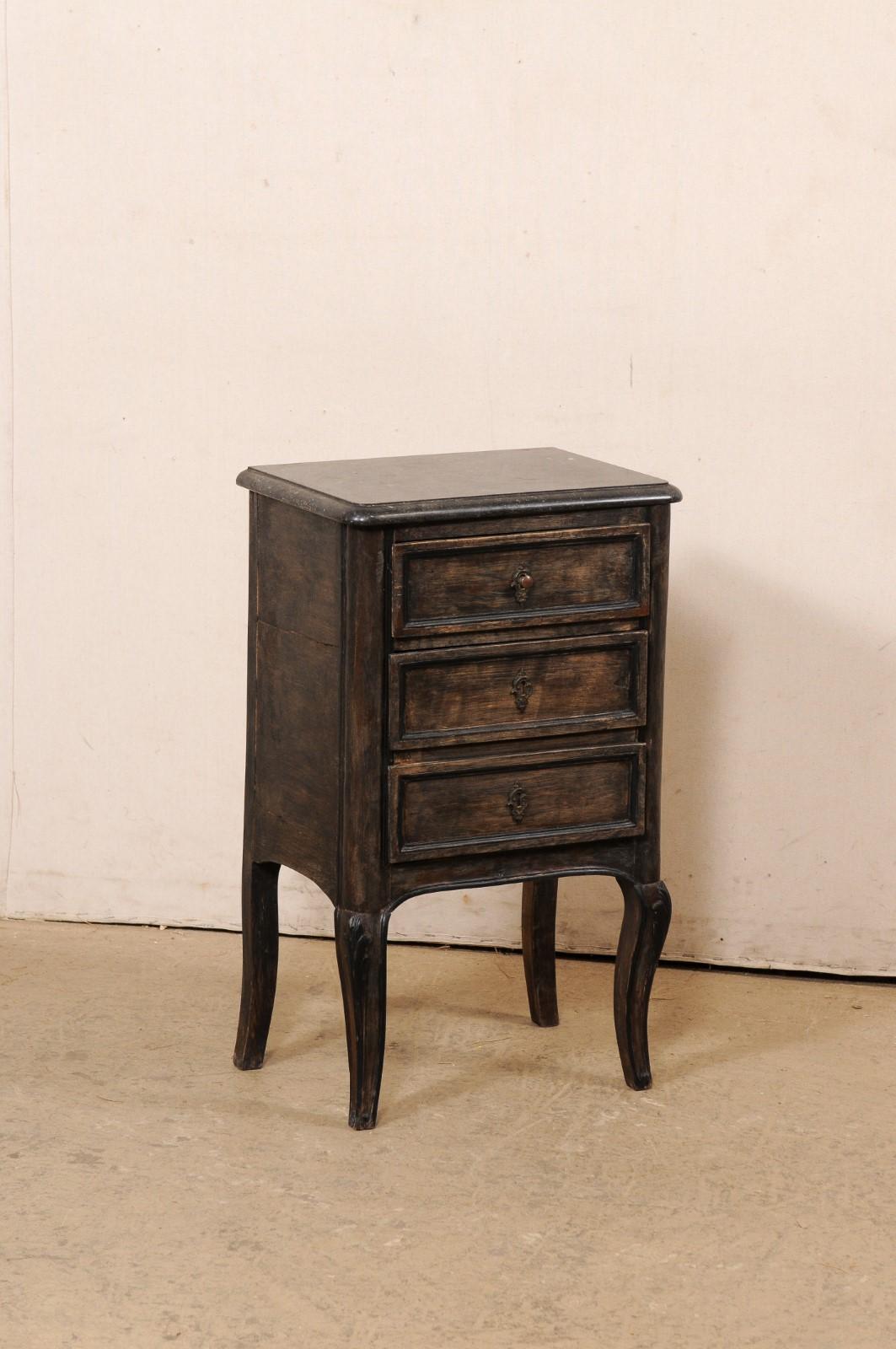 A French painted wood side chest with marble top from the 19th century. This smaller-sized commode from France has a black marble top, with case below which houses a single recessed-panel drawer above a pair of 