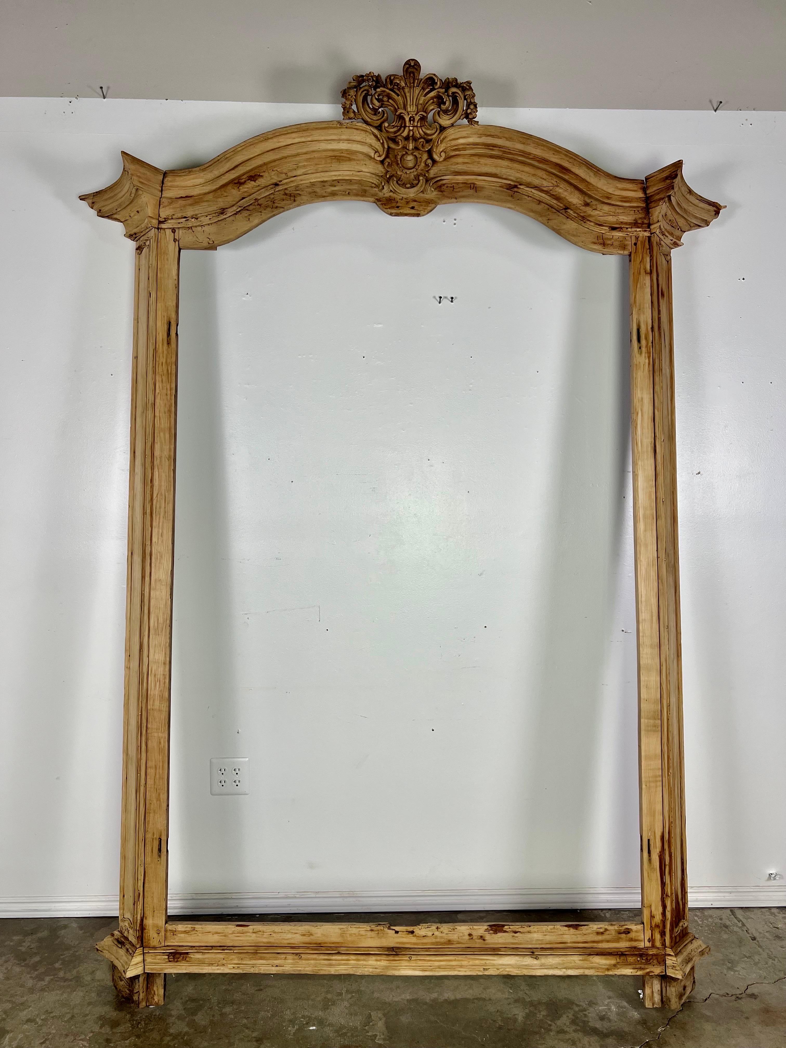Early 19th century French provincial door surround.  It would also make an incredible mirror.  The top carving is a Fleur de lys surrounded by acanthus leaves, scrolls and flowers.  There is also a bottom cartouche surrounded by acanthus leaves.  