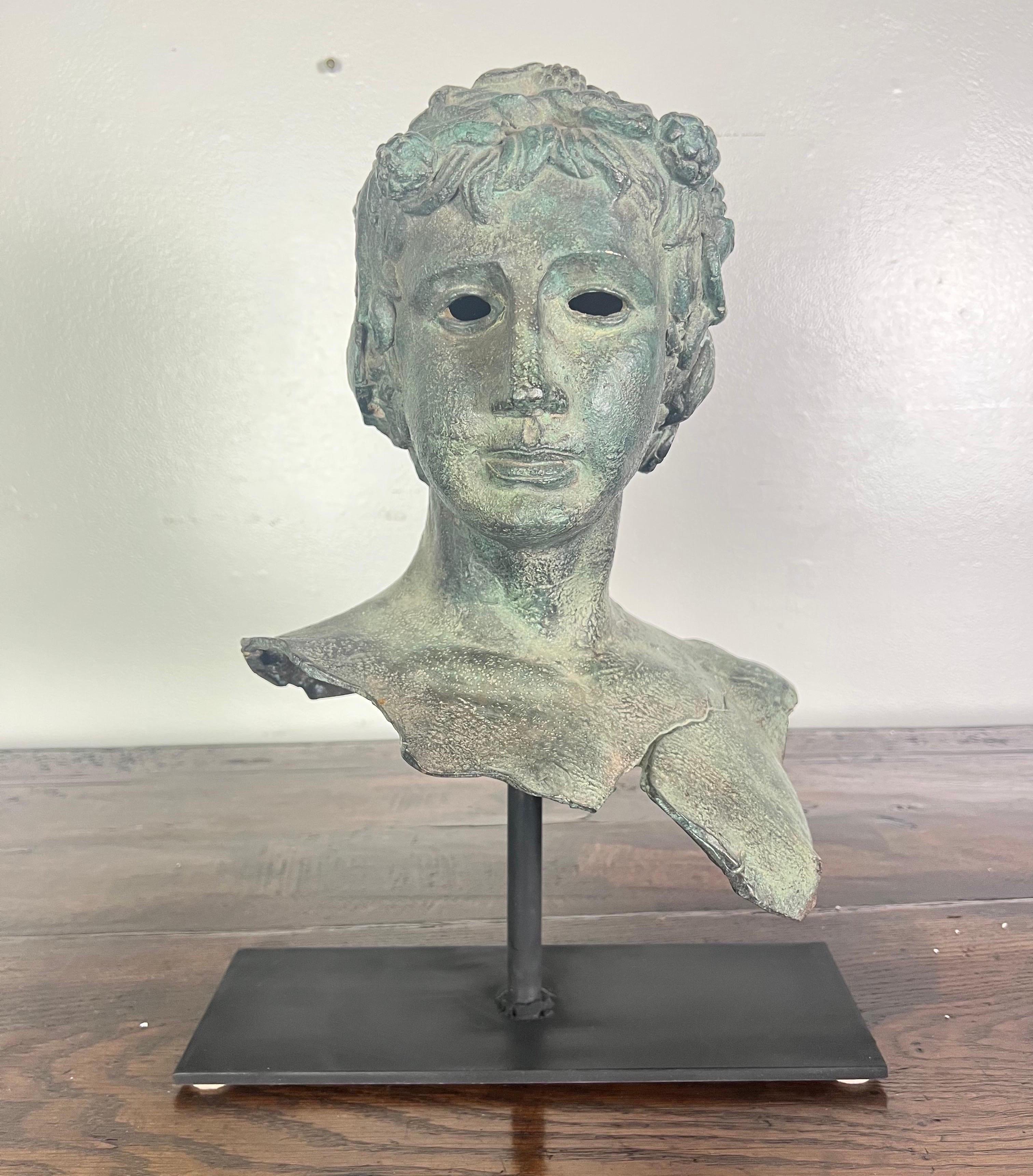 19th century French bronze head of a boy mounted on an iron base.  It is a great accent for a side table or bookshelf.