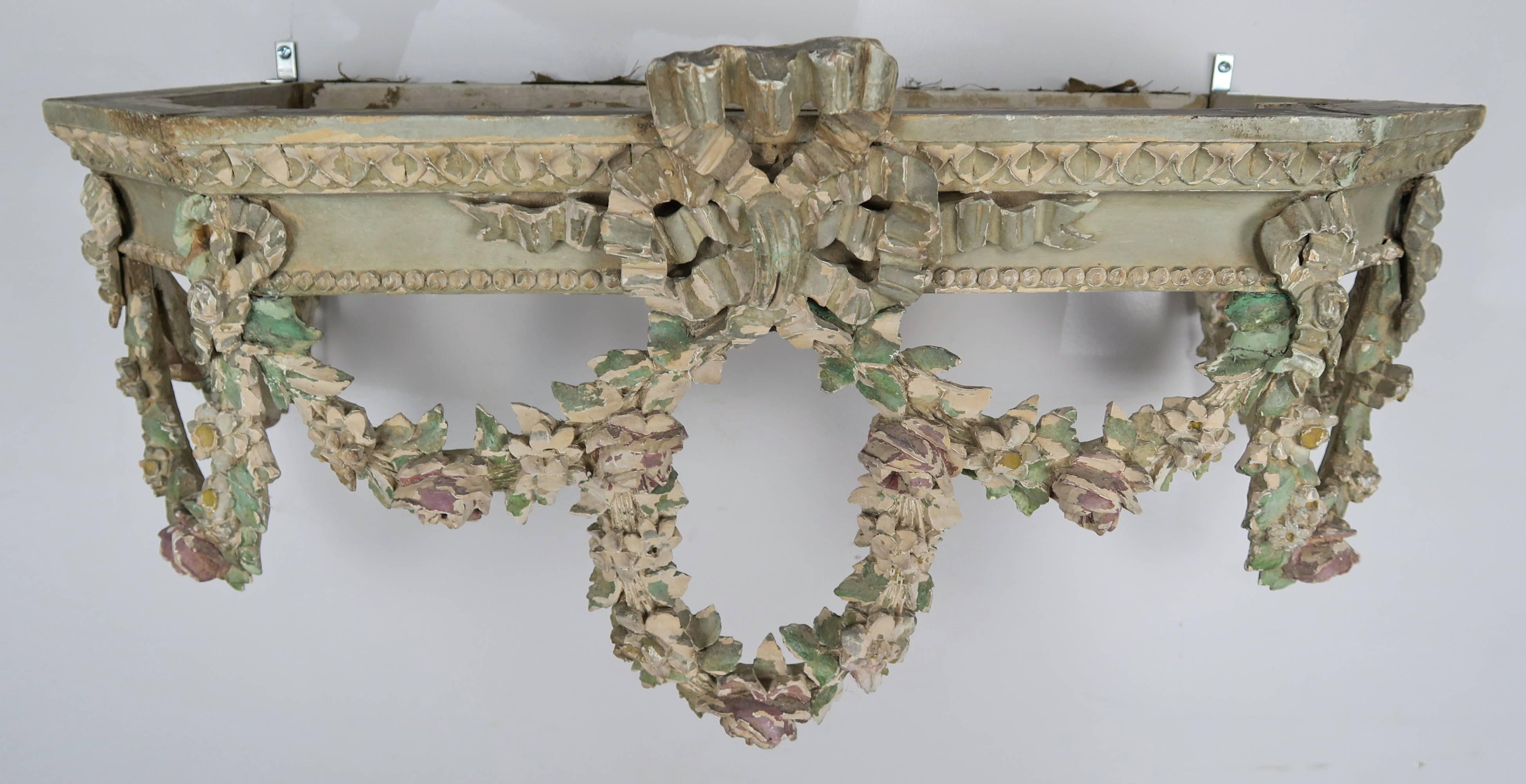 19th century French carved wood bed canopy depicting a centre bow with garlands of flowers throughout.
