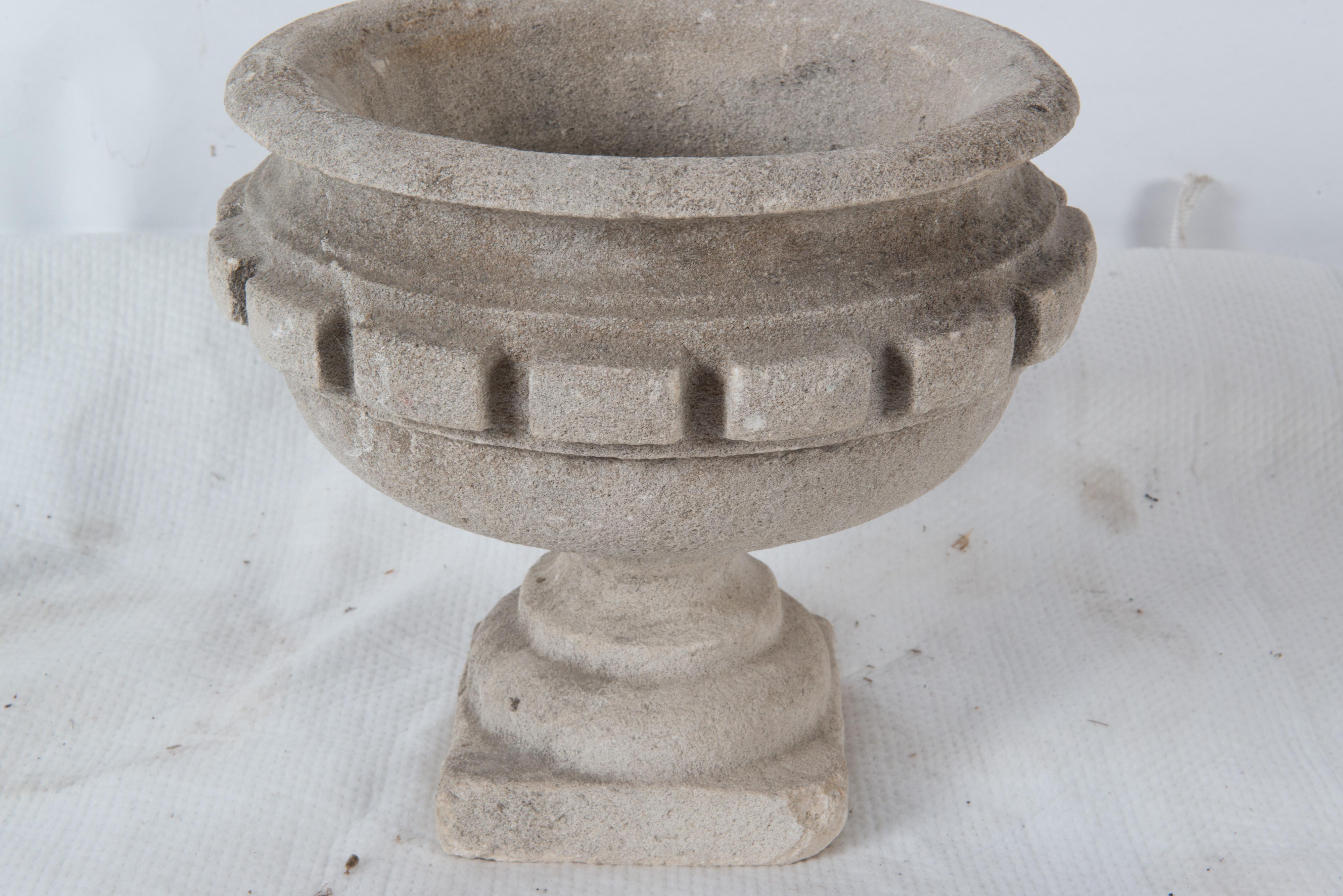 18th century carved stone French garden urn with large dental trim. This is not cast stone. One corner of the square base is missing.