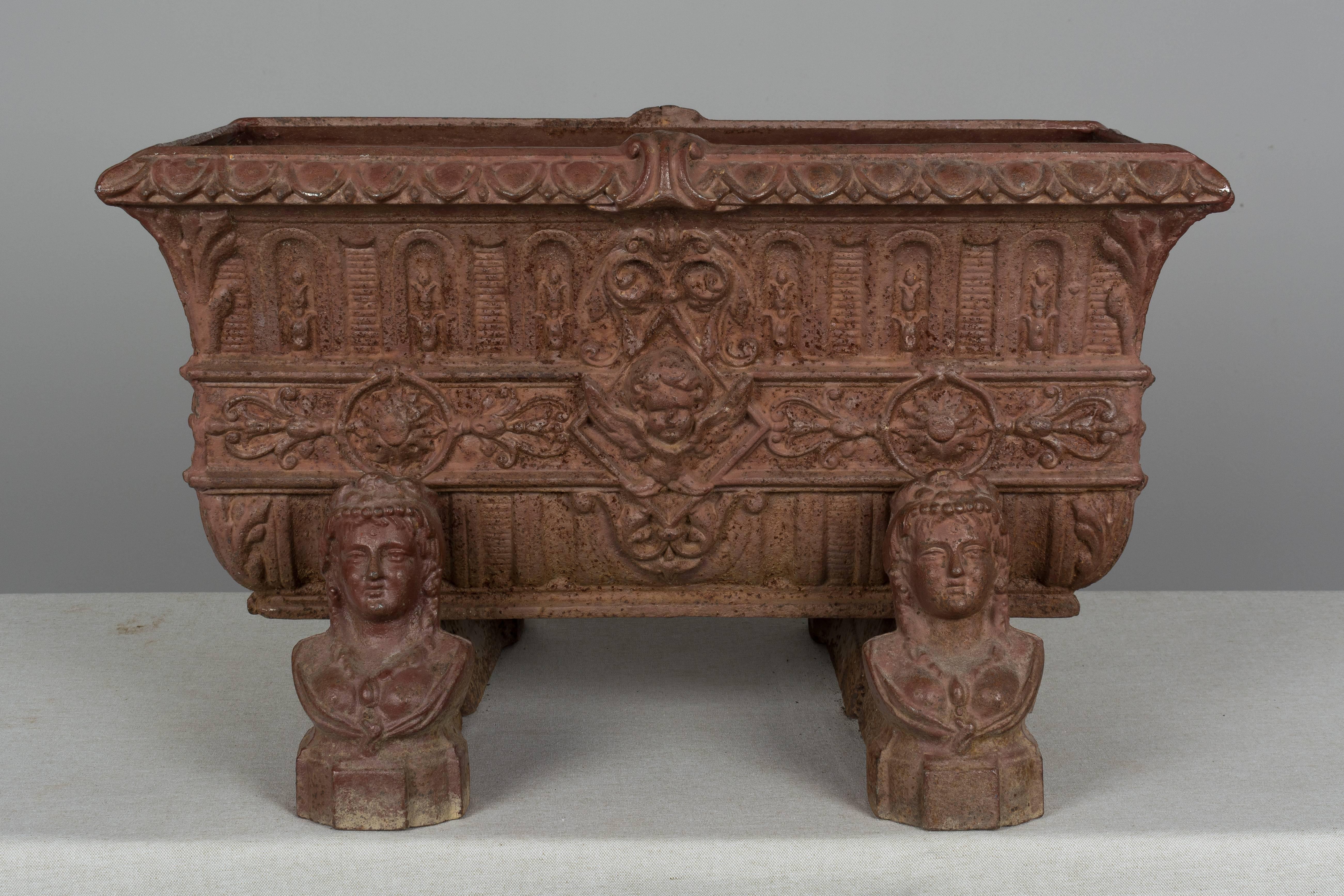 A 19th century, French cast iron planter resting on four chenets. Good detailed casting with beautiful old rusty painted color. Please refer to photos for more details. We have a large selection of French antiques at Olivier Fleury, Inc.  Please