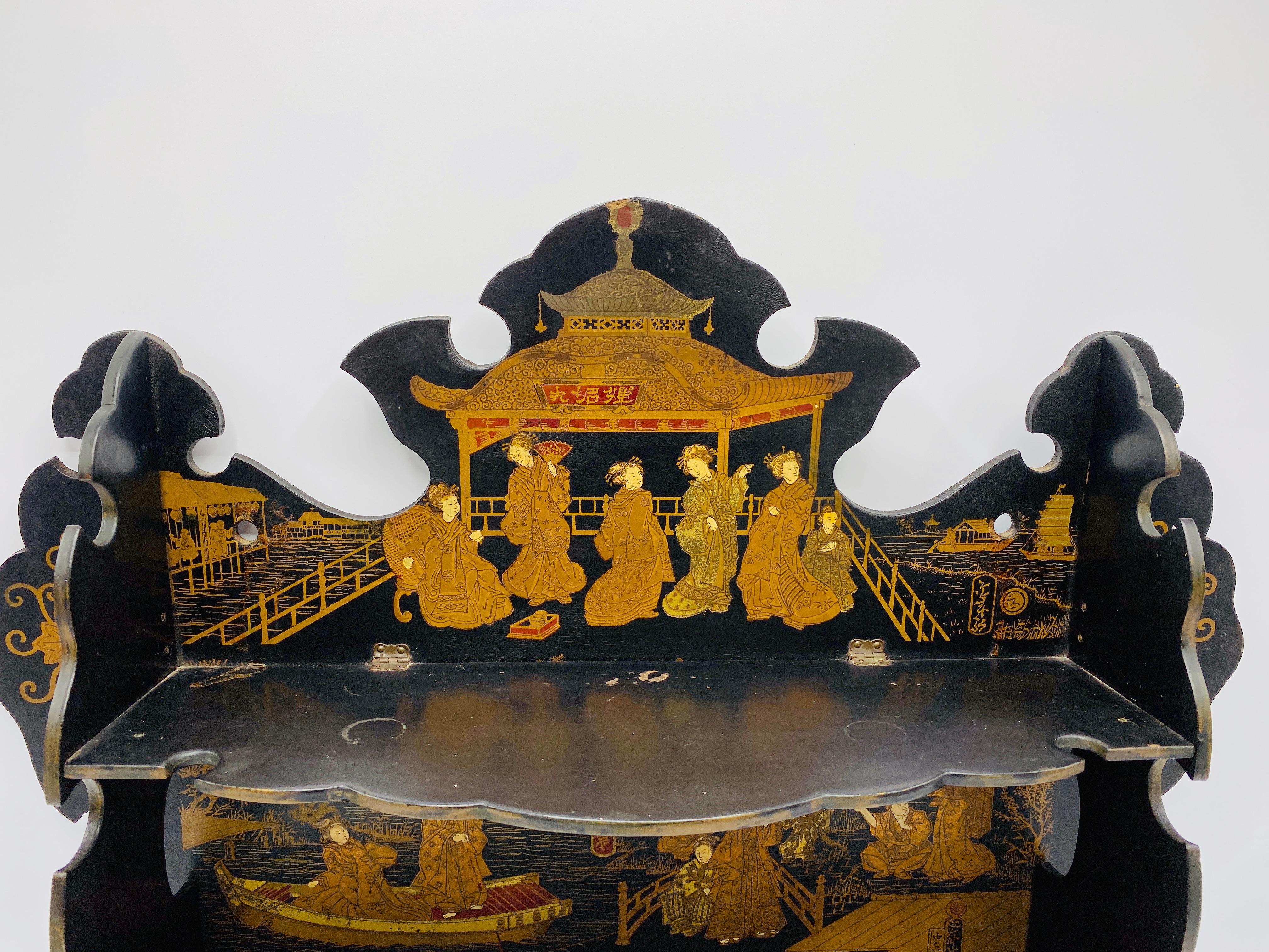 Offered is an absolutely stunning, late 19th century French, chinoiserie papier mâché japanned-lacquered pagoda shelf. The piece can hang with nails from two small holes (in upper portion) or sit freestanding on a flat surface. Four sets of