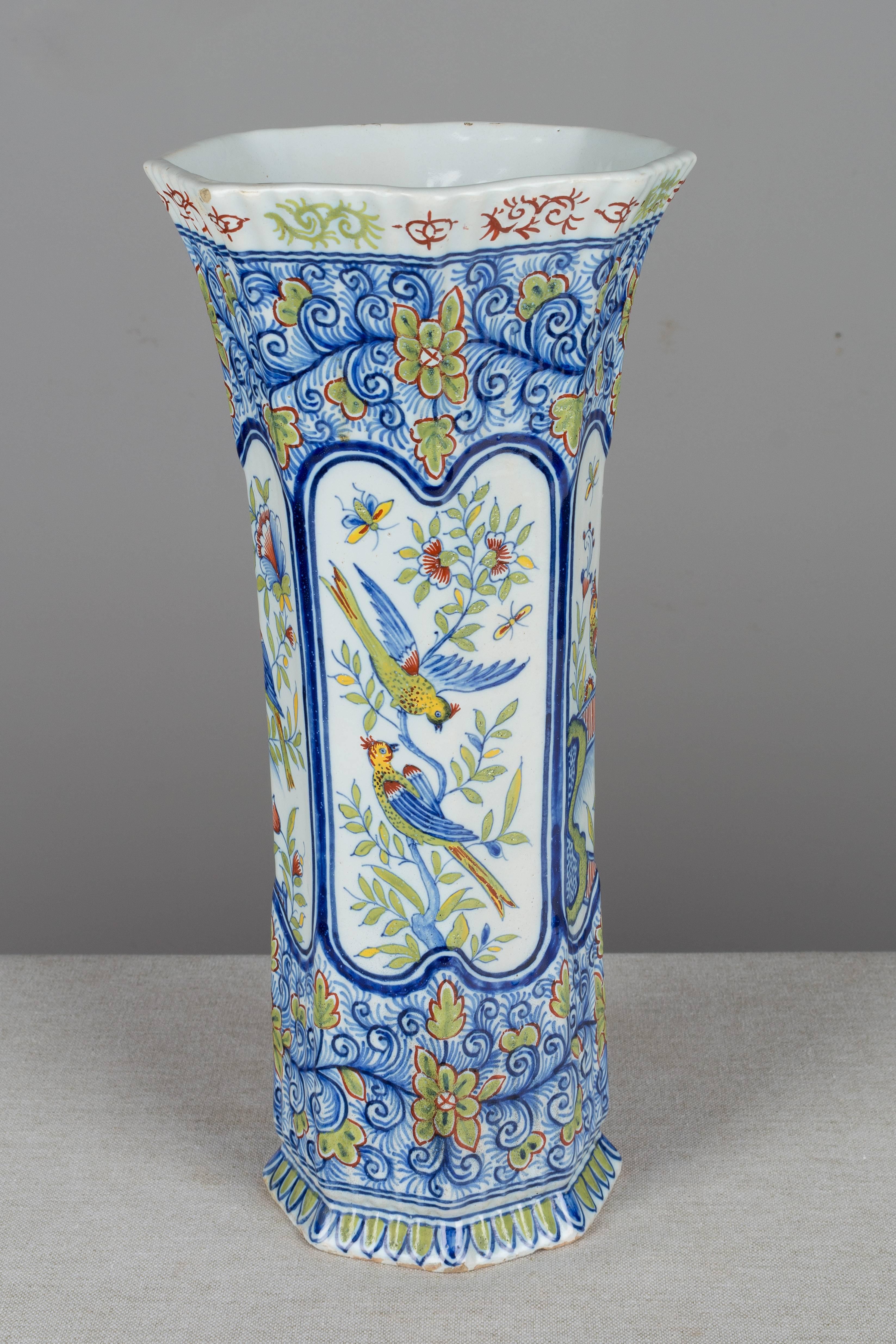 A 19th century French Desvres hand-painted faience vase. Fourmaintraux Courquin mark on underside. Minor chips to base. Measures: Top diameter is 6.25