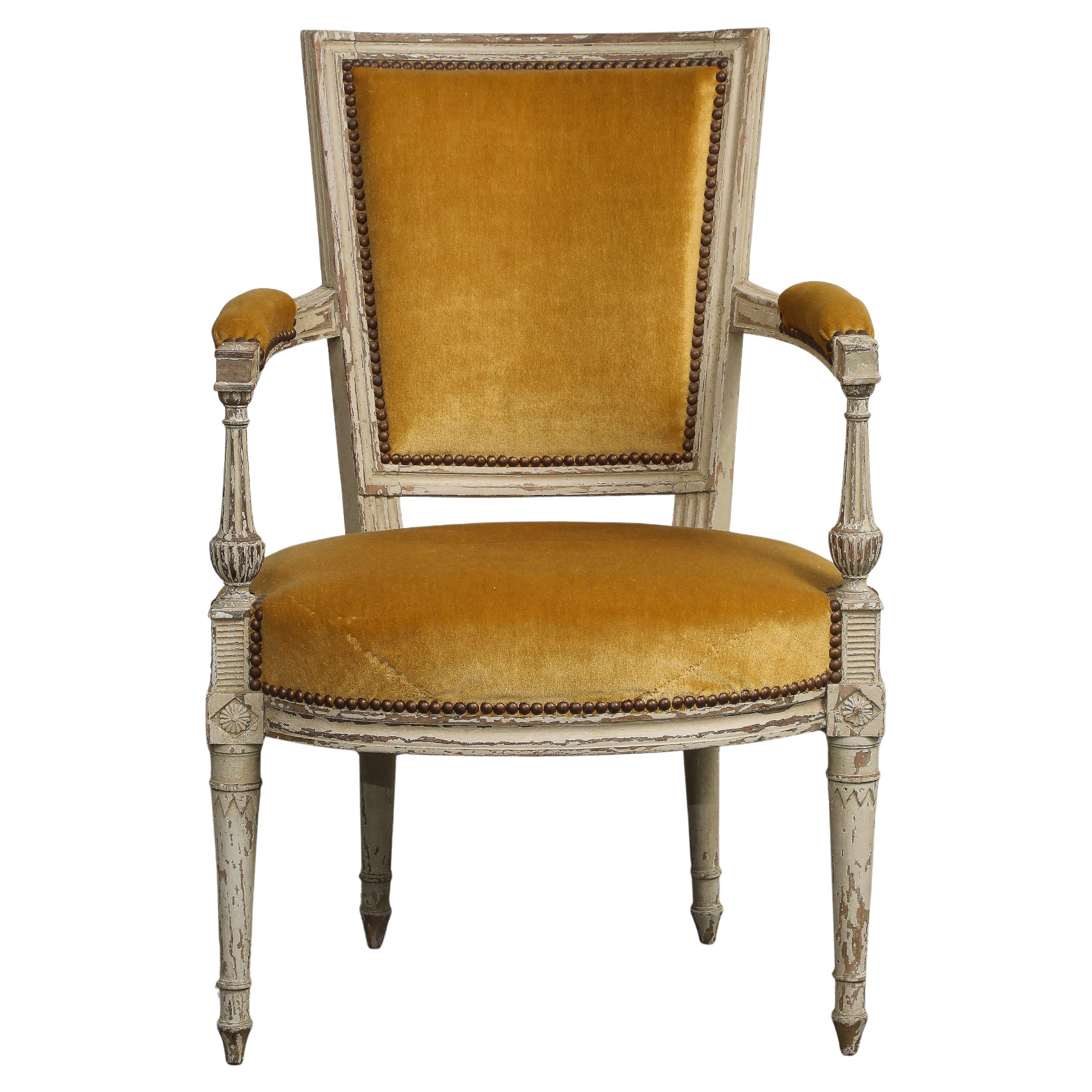 19th Century French Directoire carved walnut armchair with white paint and gold velvet upholstery. 
