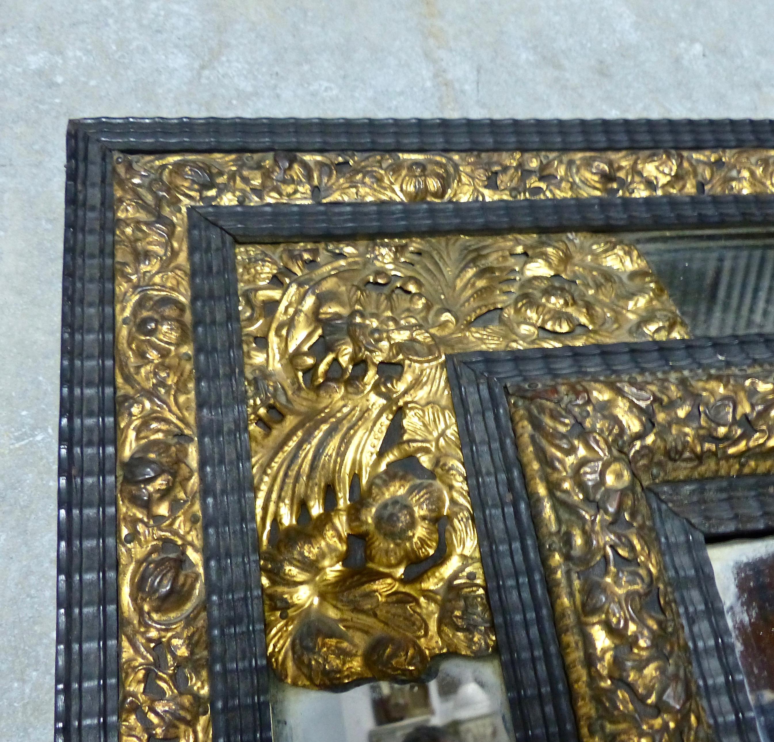 A circa 1870 ebony framed French mirror accented with gold leafed brass. Delicate floral details in the repousse (hand-hammered from the reverse) gilt brass. Timeless and unique.
Dimensions: 39 H” x 29 W”.