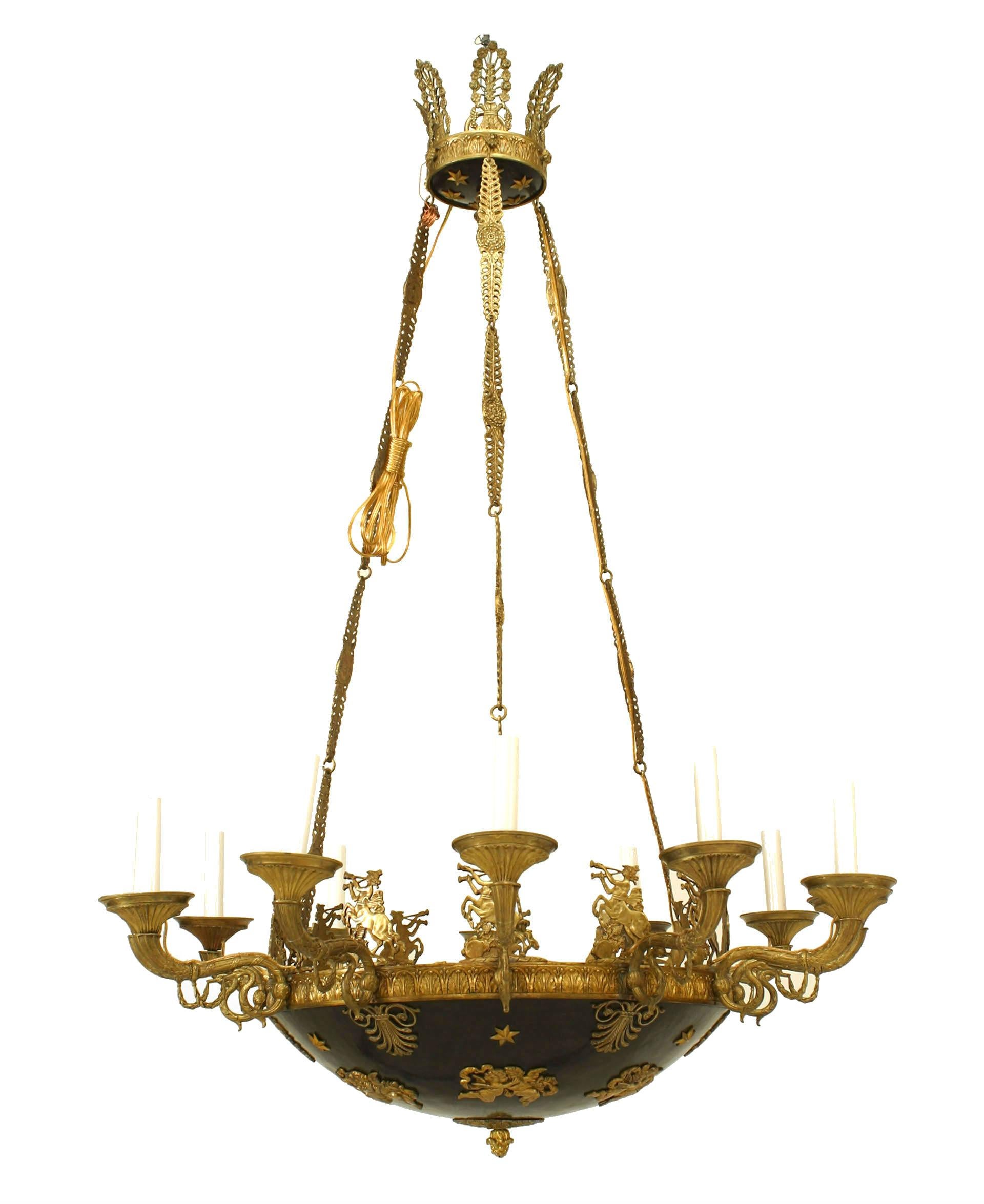 French Empire (19th Century) chandelier with a bronze ebonized patina bowl with gilt trim and 12 scroll uplight arms trimmed with a finial bottom and supported with 3 chains connected to a canopy.
