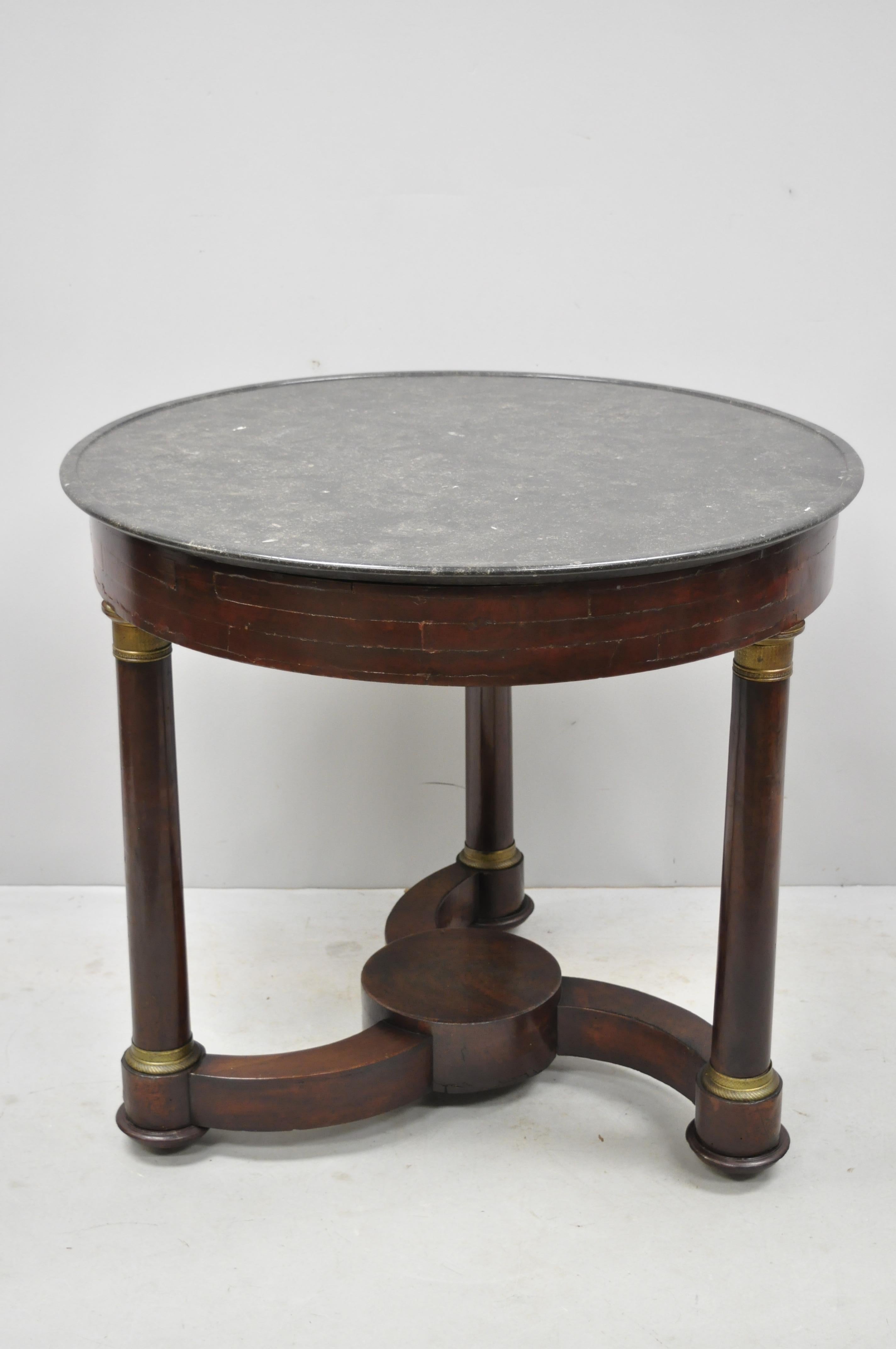 19th century French Empire mahogany round marble top center table with brass ormolu. Item features unique round marble 