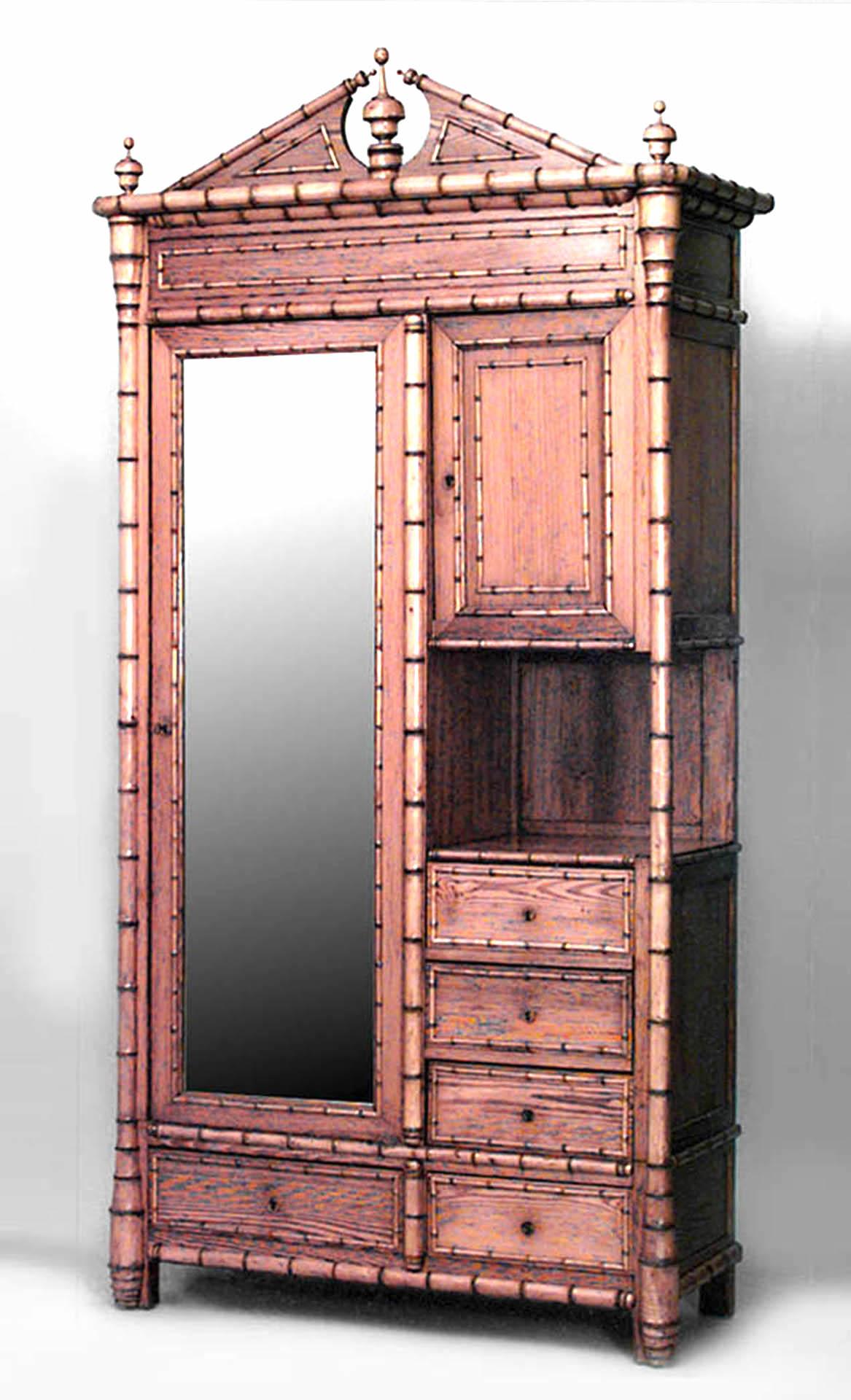 French Victorian faux bamboo pine and maple trimmed armoire cabinet with large mirrored door, 1 small door, 5 drawers & shelf with open pediment top.
