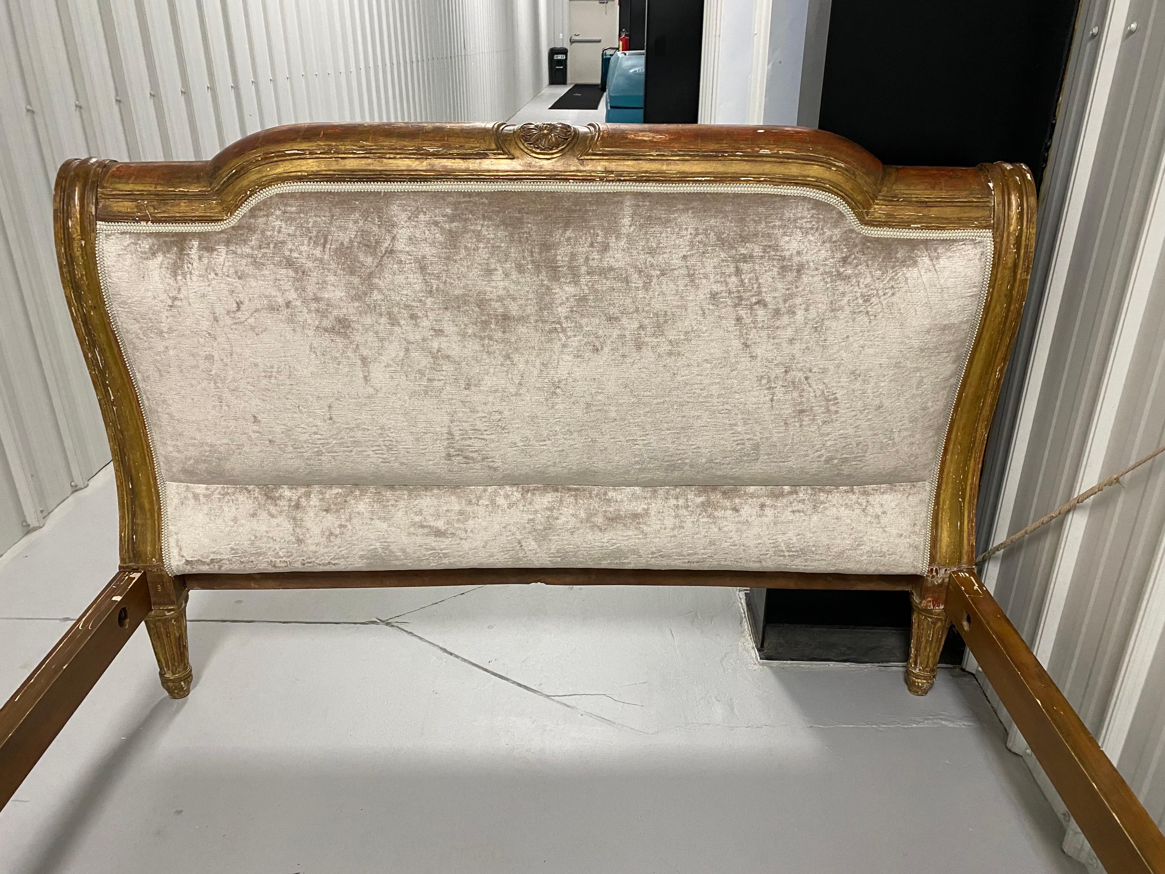 A 19th Century French Gilt-wood Queen Size Headboard and footboard together with later side rails and customized cut out platform and mattress made by Charles H Beckley.  In 1997, the noted Interior Designer, David Easton, sourced the antique head