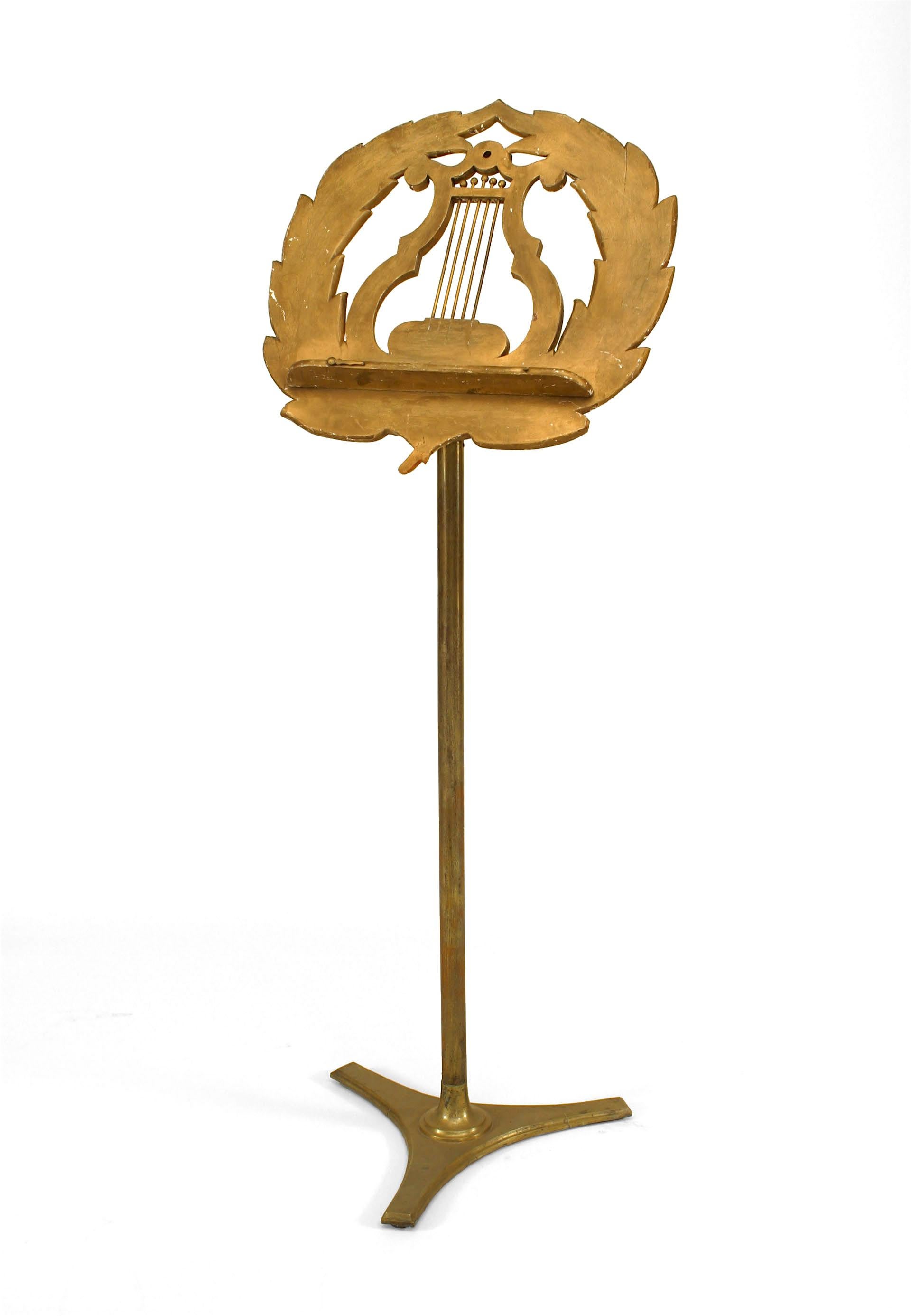 Nineteenth century French adjustable brass music stand with a giltwood lyre design top supported by a column and triangular base.