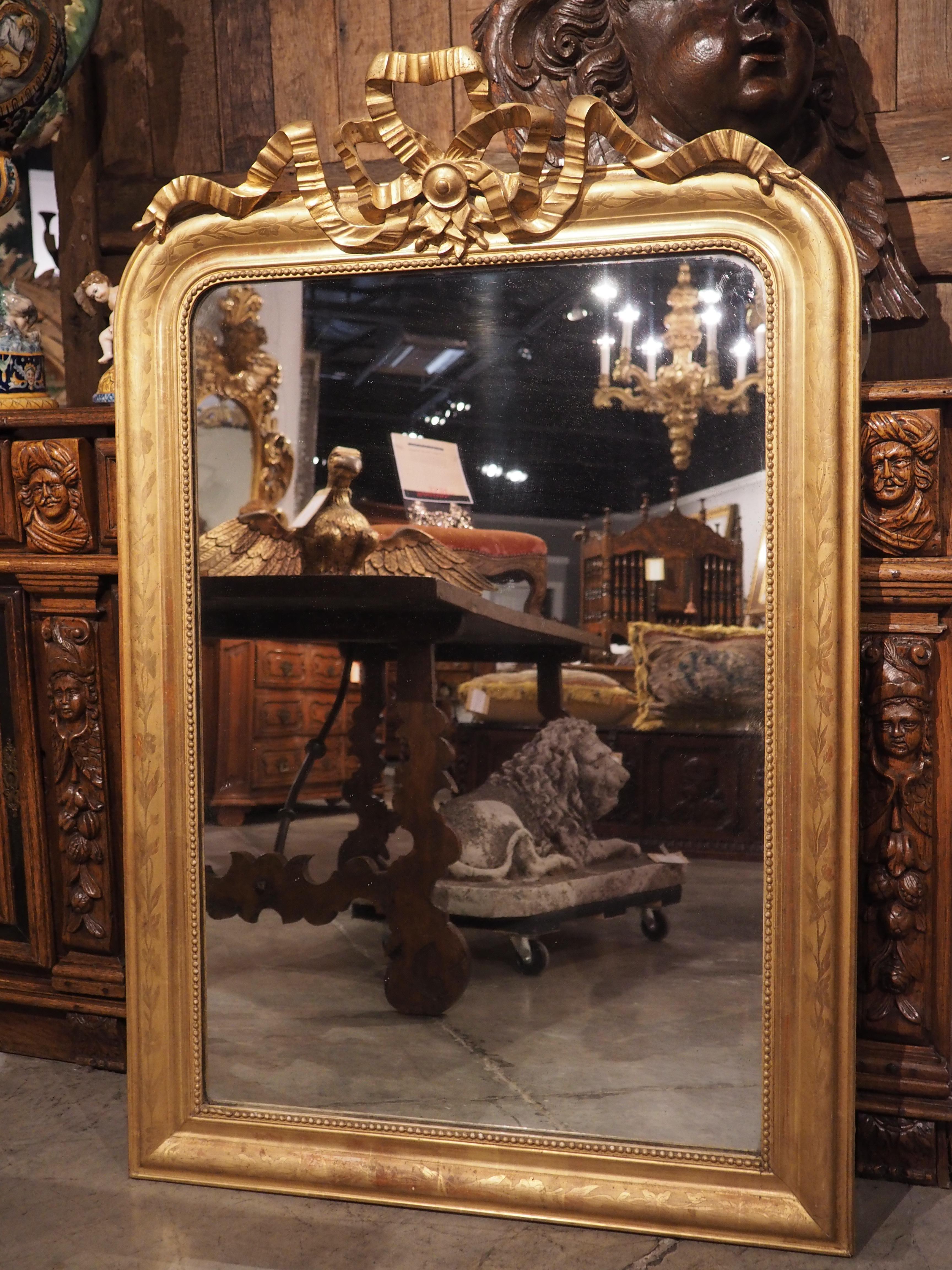 Hand-Carved 19th C. French Gold Louis Philippe Mirror with Crinkled Bow and Floral Motifs
