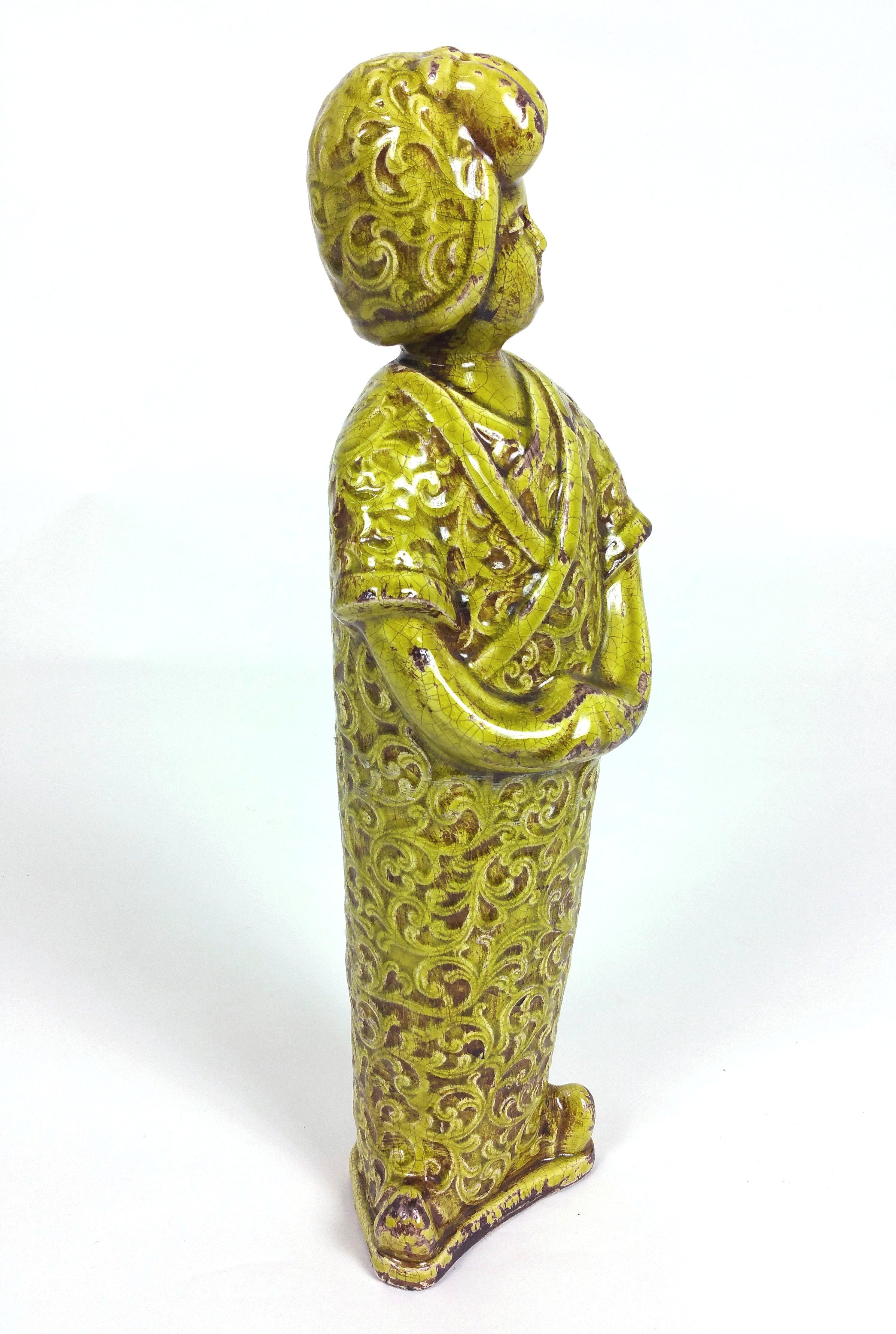 This 19th century French large pottery figure of a geisha in the Japanese style, finished in an apple green glaze, which now has a crackled overall finish. It measures 7 in – 17.8 cm wide, 3 ½ in – 9 cm deep and 20 ½ in – 52 cm in height.
