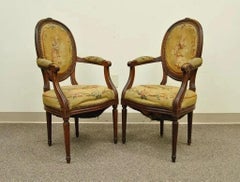 19th C. French Louis XVI Style Carved Walnut Needlepoint Arm Chairs - a Pair