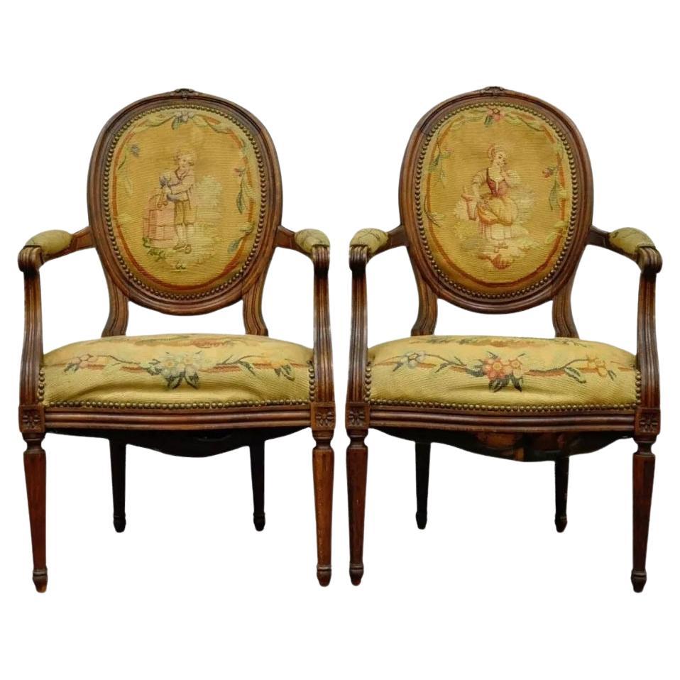 19th C. French Louis XVI Style Carved Walnut Needlepoint Arm Chairs - a Pair
