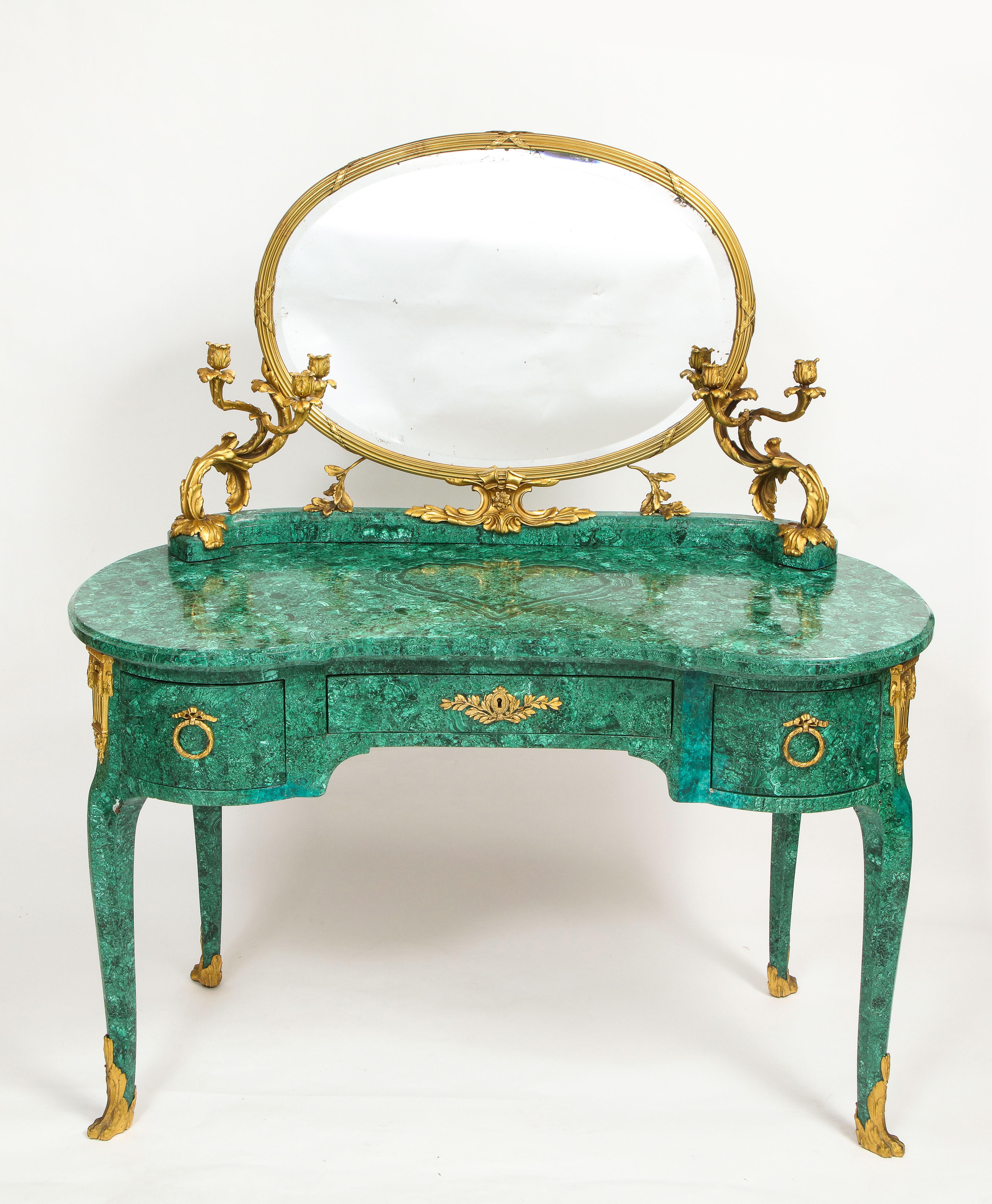 An Incredible and Spectacular 19th Century French Louis XVI Style Dore Bronze Mounted Mirrored Malachite Dresser with Candelabra arms.  The malachite body of the dresser is hand crafted from a semi-precious stone, highly sought after for its unique