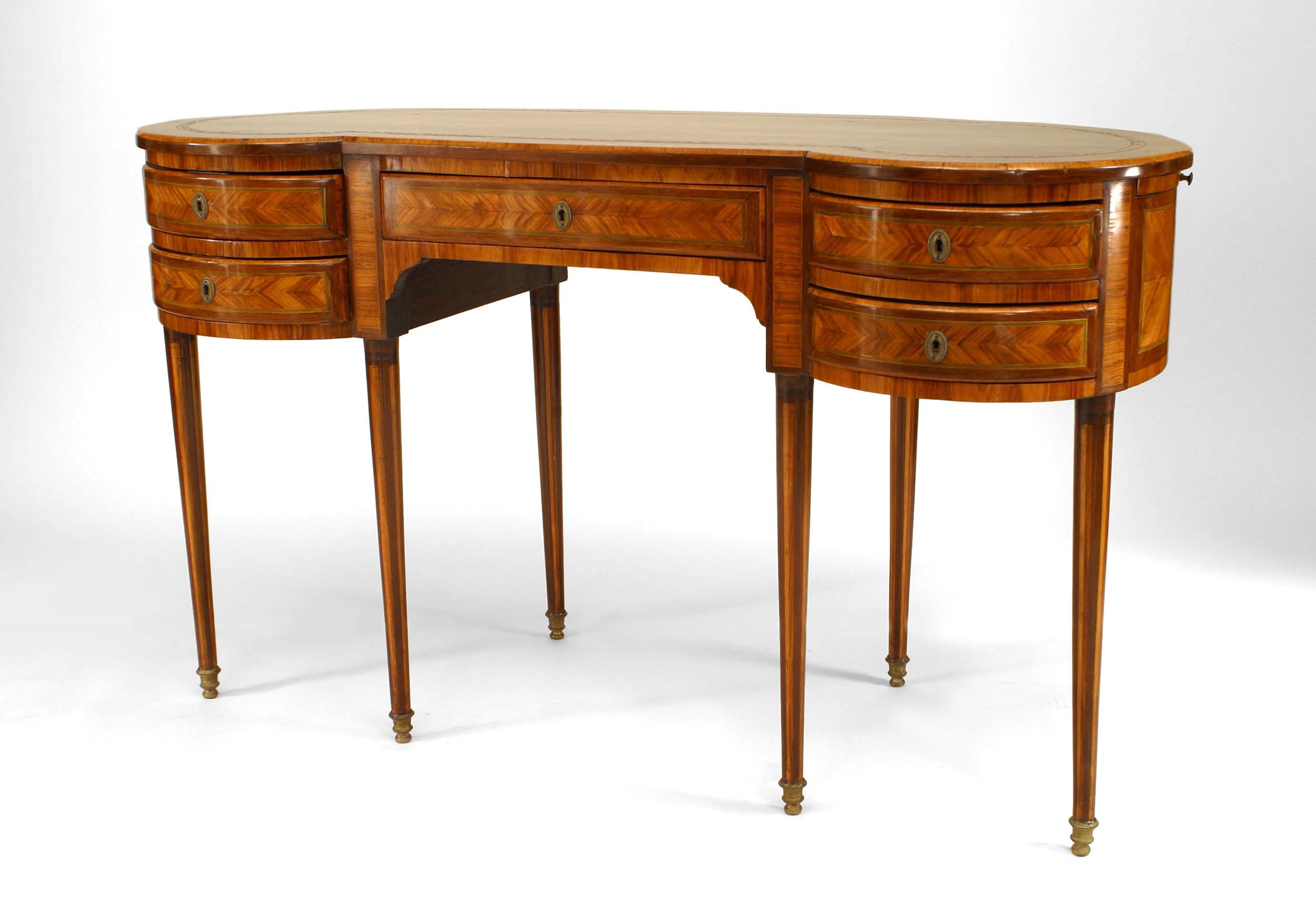 French Louis XVI style (19th Century) satinwood and inlaid 6 legged kidney shaped desk with side slides.
