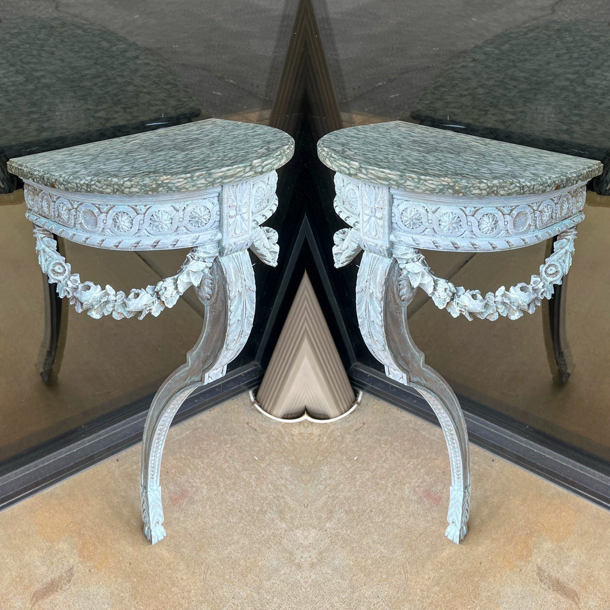 I love the marble on these Louis XVI style wall mounted console tables. They date to the later part of the 19th century, and each table has been lymed or white washed. The carved barbola swags are in very good condition. The marble is very