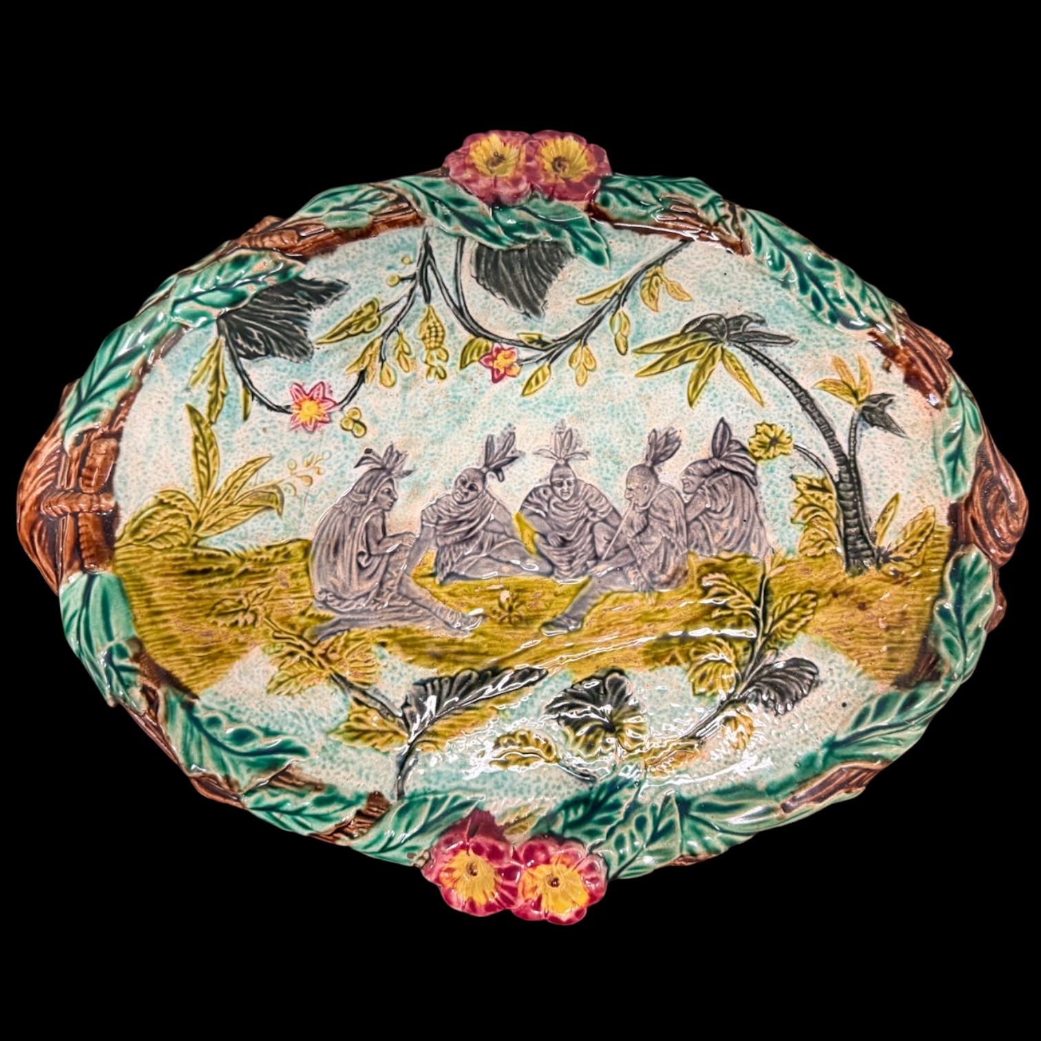 This is Wonderful and rare French majolica platter or tray. It dates approximately to 1870. It depicts seated Native Americans with palm trees in the landscape. The scenery implies that it is probably the Seminoles in Florida. During this Victorian
