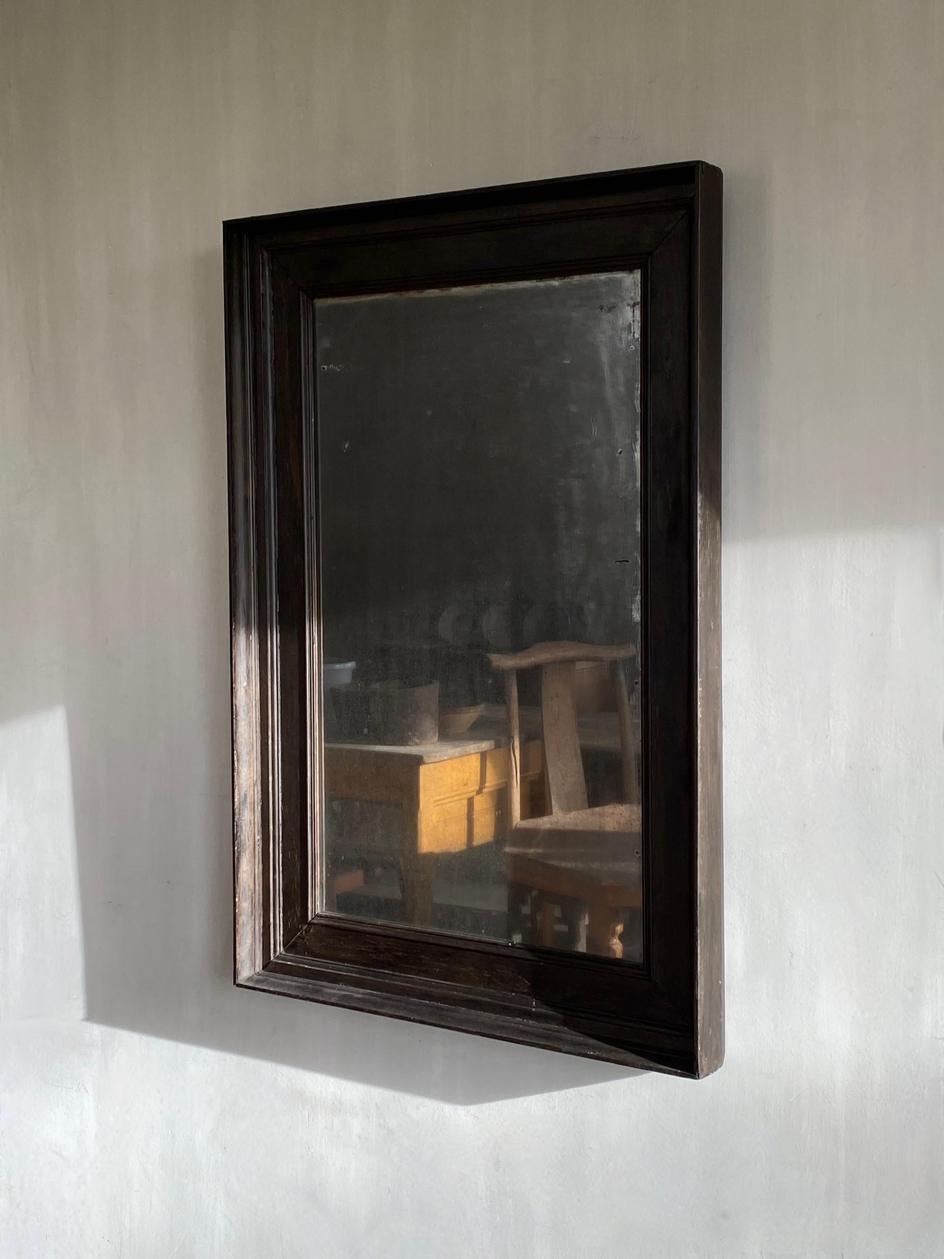 A 19th century French simplistic mirror with original weathered mirror glass.
The mirror glass has a beautiful soft fuméé effect.
The frame is set in ebony.

Pure and sober.

We ship safely worldwide, feel free to ask for your personal rate.