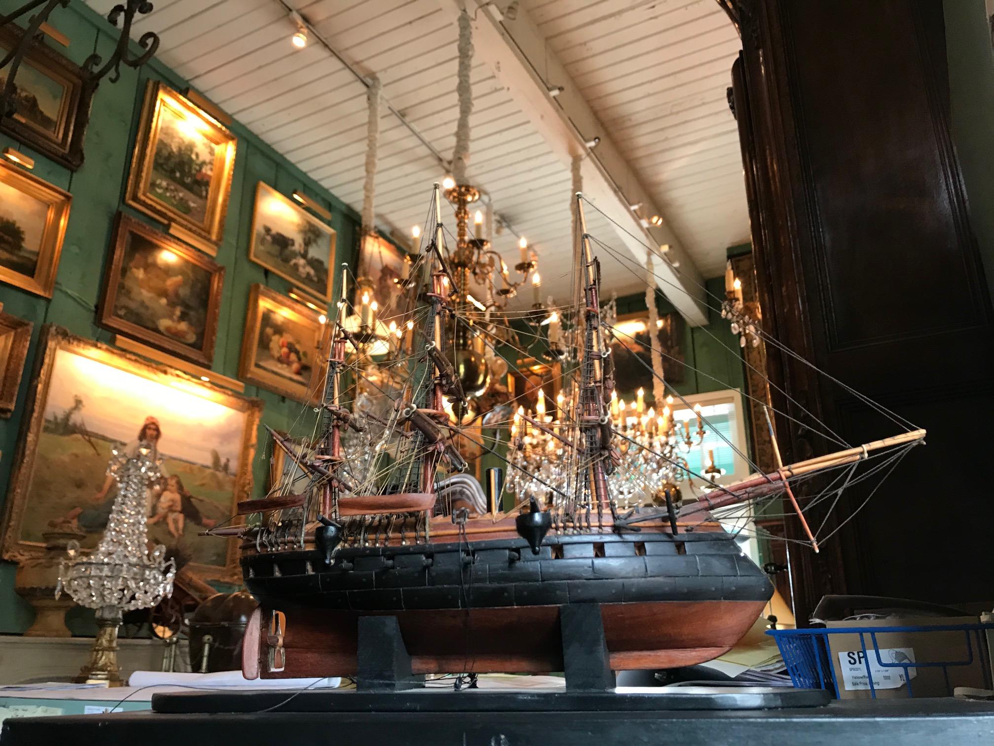 A beautiful 19th century painted wood model of a French sailing battle ship, It comes with a small miniature model of a ship as well. Height 13 ¼” width 16 ½” x 7” width. The scale is perfect as it had to be and the quality of work is evident.