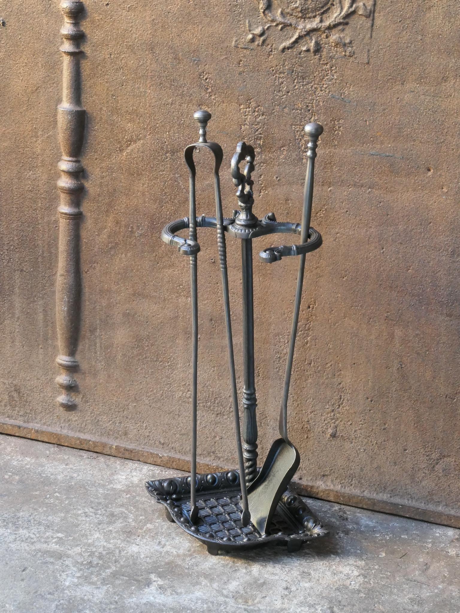19th century French Napoleon III fireplace tool set. The tool set consists of thongs, shovel and stand. Made of cast iron and wrought iron. It is in a good condition and is fully functional.