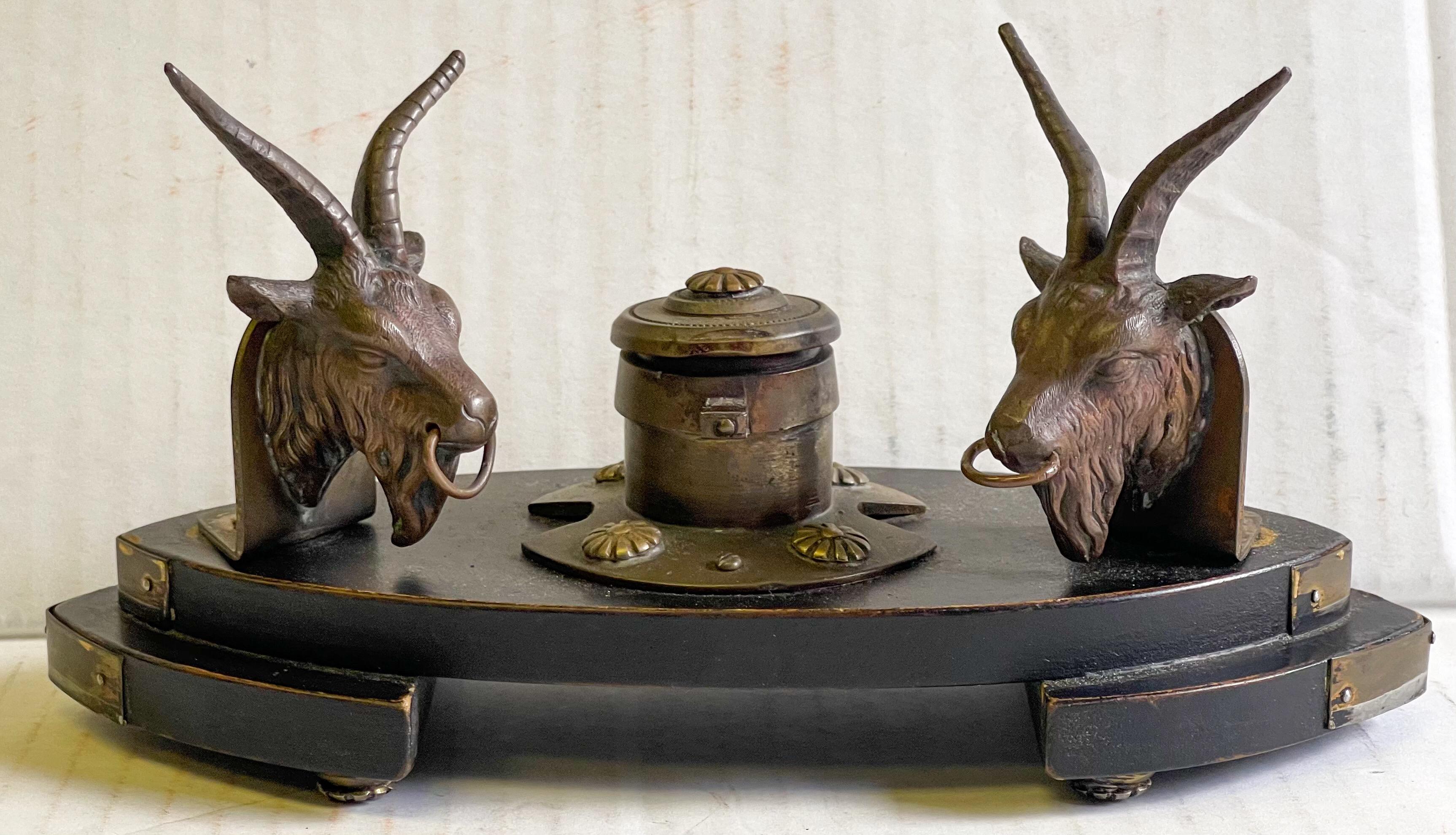 This is a mid-19th century French gilt bronze neo-classical style ram form inkwell. It has dual rams to possibly hold the writing instrument.