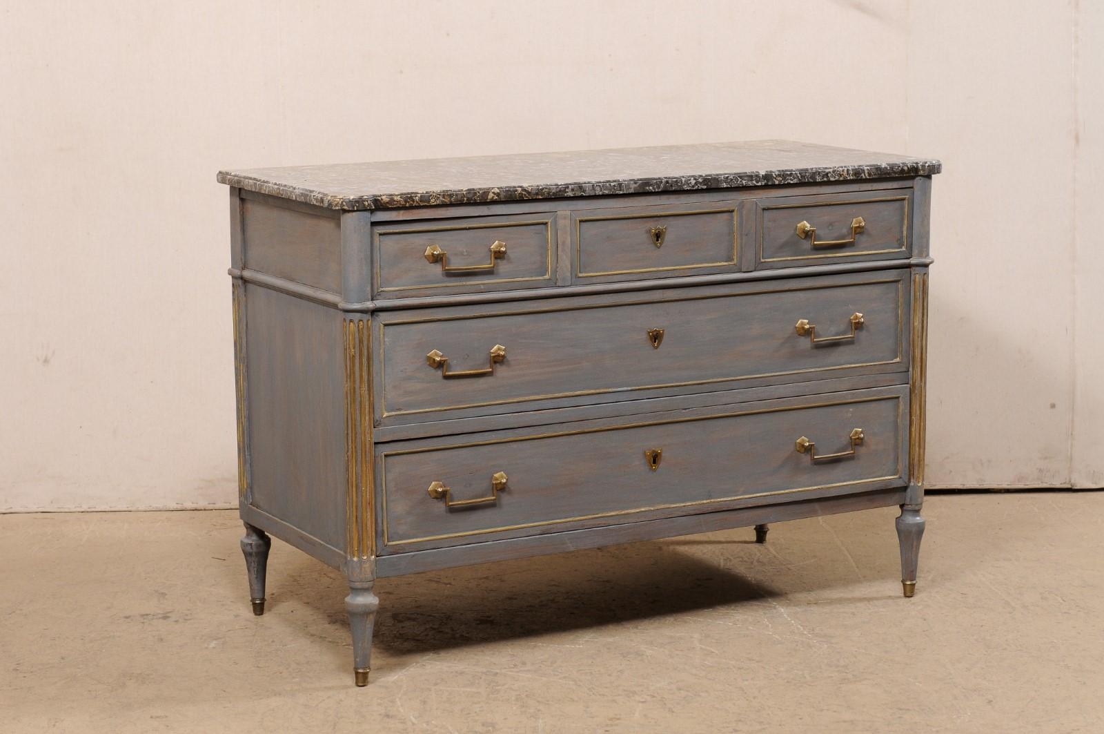 A French Neoclassical commode with its original marble top from the 19th century. This antique chest from France features a rectangular-shaped marble top, with pronounced rounded front corners, which rests atop a neoclassical case with rounded and