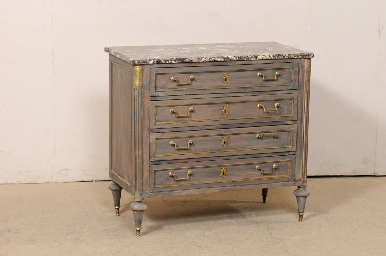 A French neoclassical style commode with marble top from the 19th century. This antique chest from France features its original rectangular-shaped marble top, with pronounced rounded corners, which rests atop a neoclassical style case with rounded