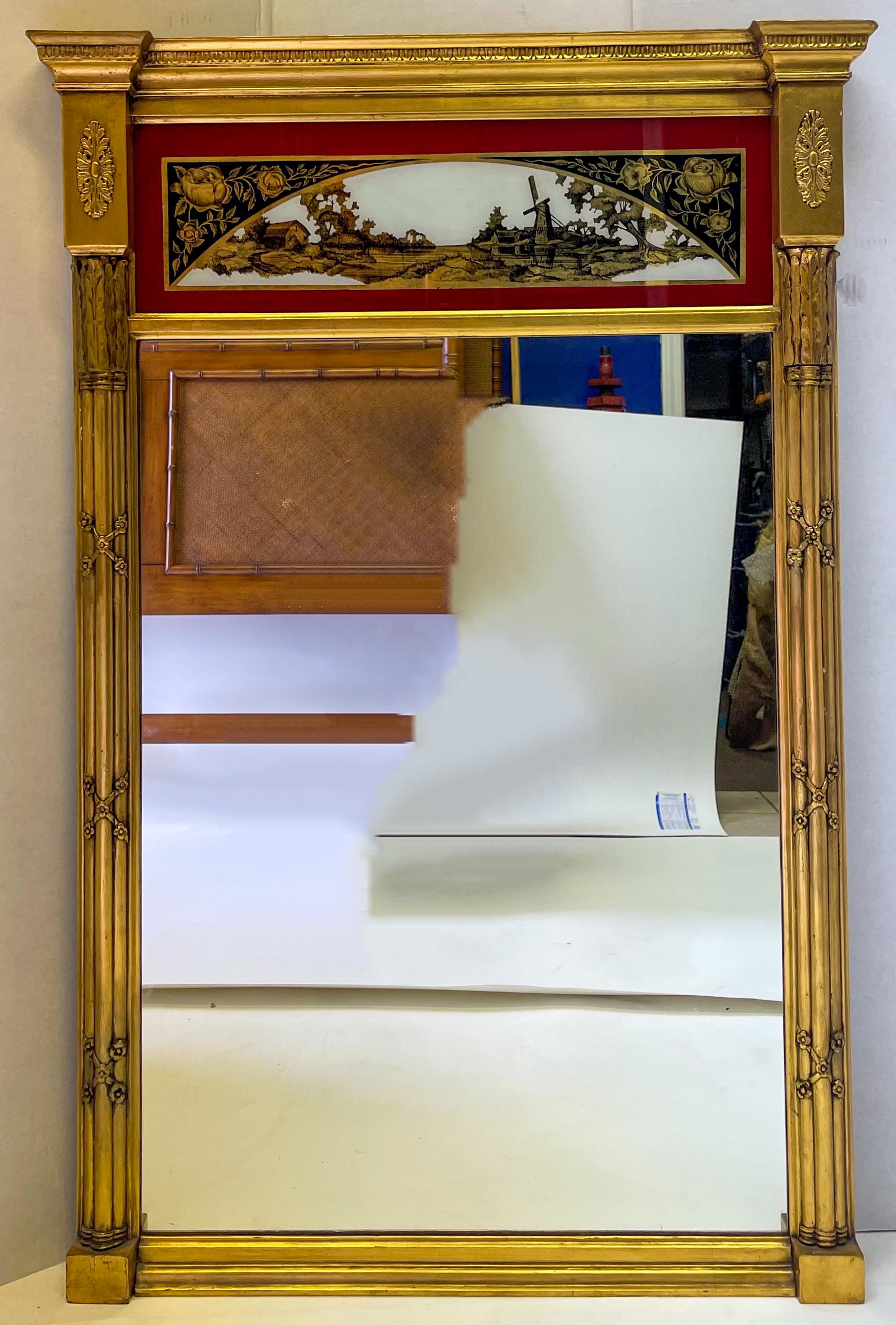This is an exceptional French water gilt trumeau mirror with neoclassical styling. The panel is eglomise with a pastoral scene in a deep red, black and gilt. It dates to the late 19th century and is in very good condition.