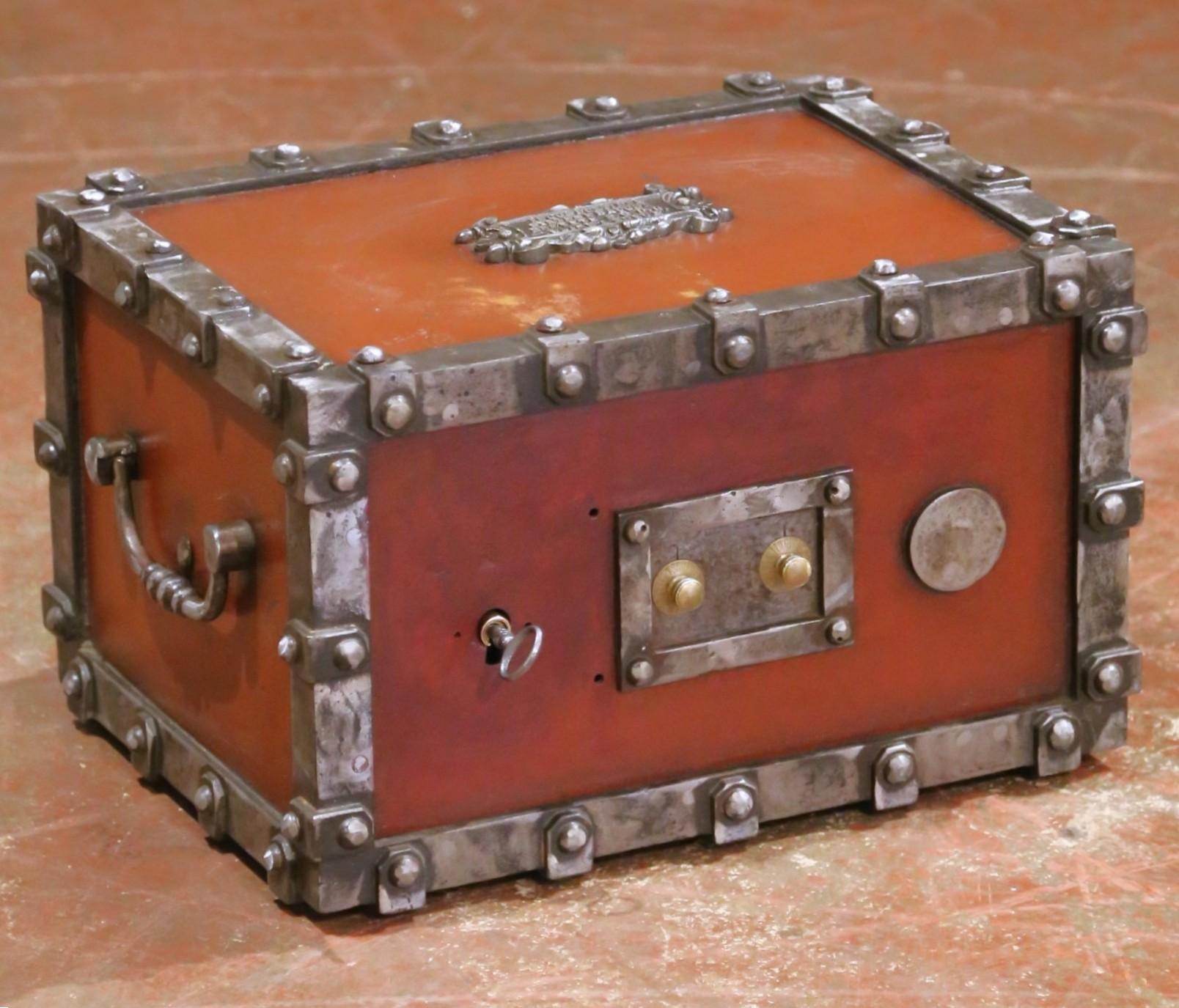 This antique French safe was crafted circa 1880 in the Champagne-Ardenne region by Bauche, renowned for their patented “Système Incombustible” fireproof designs. Weighing 78 pounds, the cast iron coffre-fort is clad in riveted steel strapping with