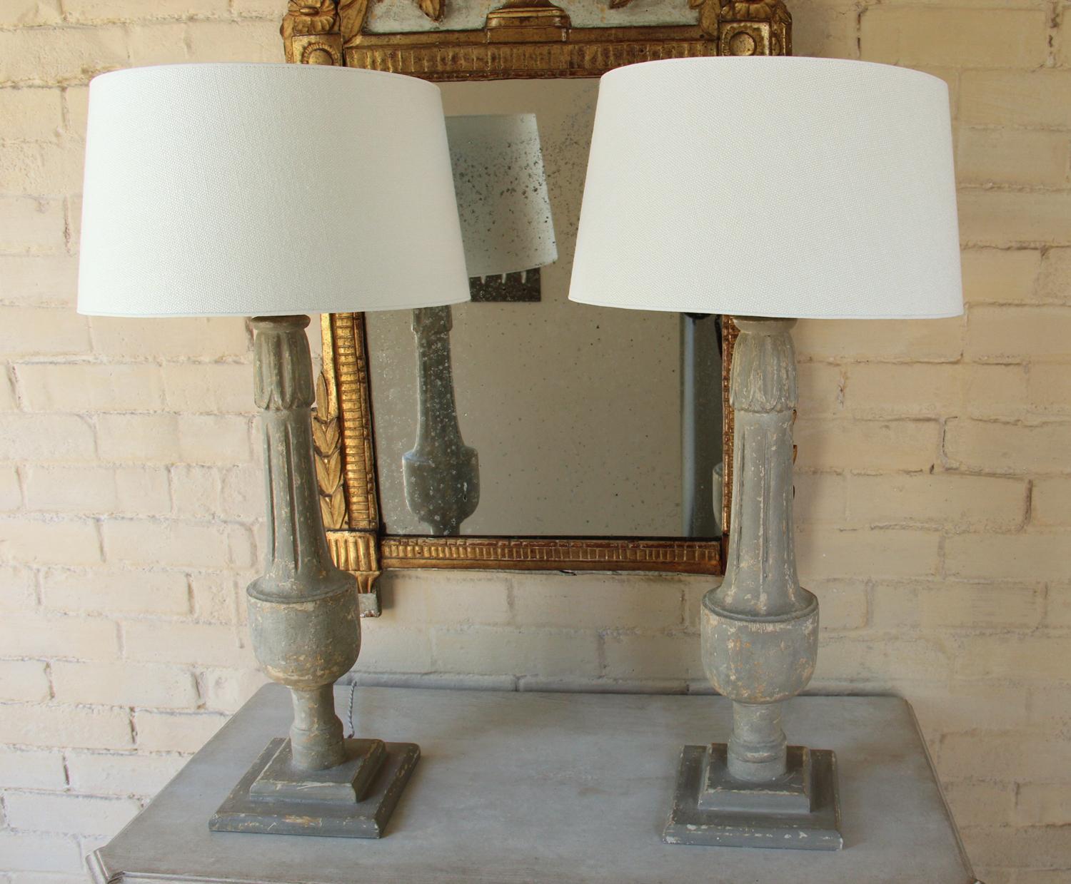 A beautiful pair of 19th c. French balustrades converted to table lamps with braided French cords. The patina is a very neutral aged gray. The lampshade is handmade in Belgium of fine linen and has a high quality gold foil inner lining. The lining