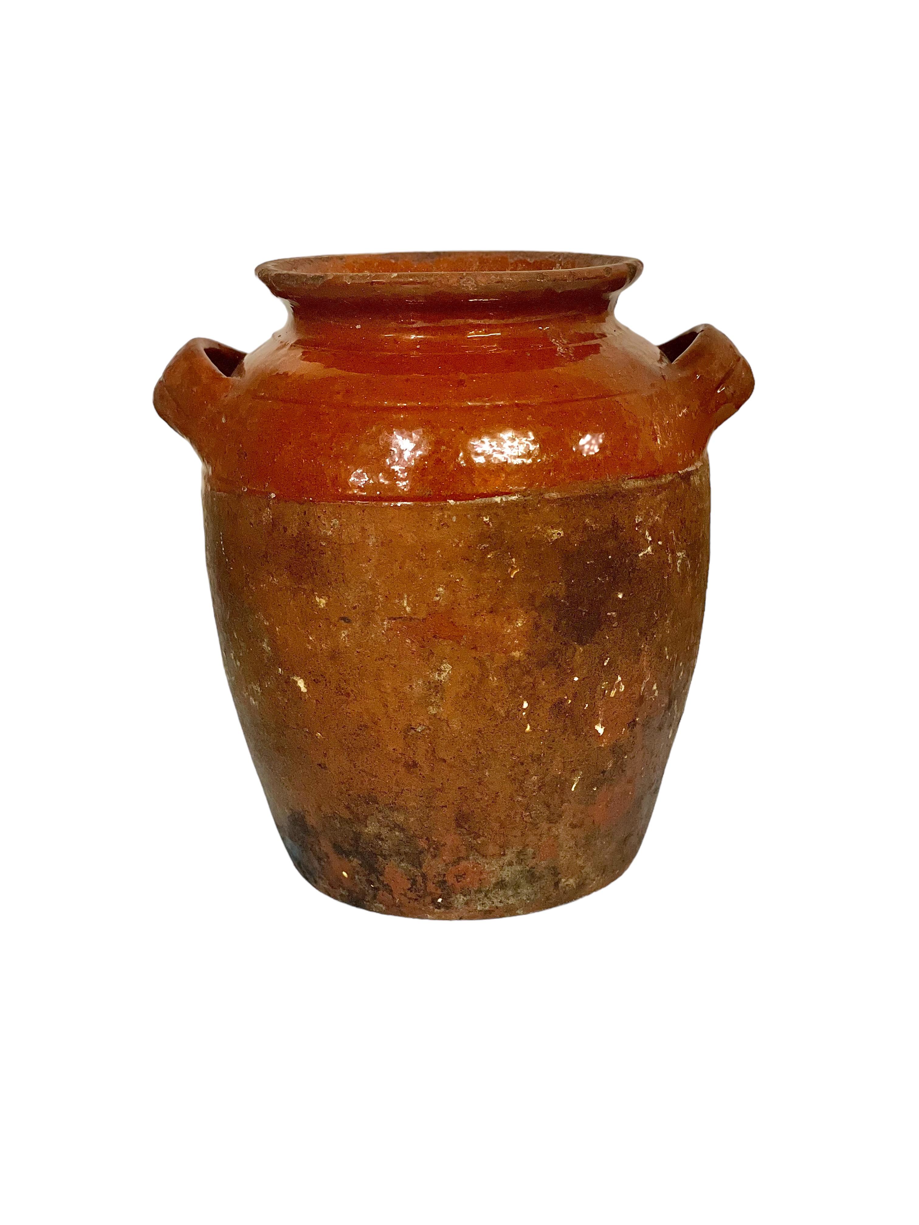 A small and beautifully shaped Provençal 'Confit Pot', made from traditional terracotta, and featuring the customary half-glazed exterior. Two elegantly formed side handles complete its practical design. These quintessentially French clay pots had