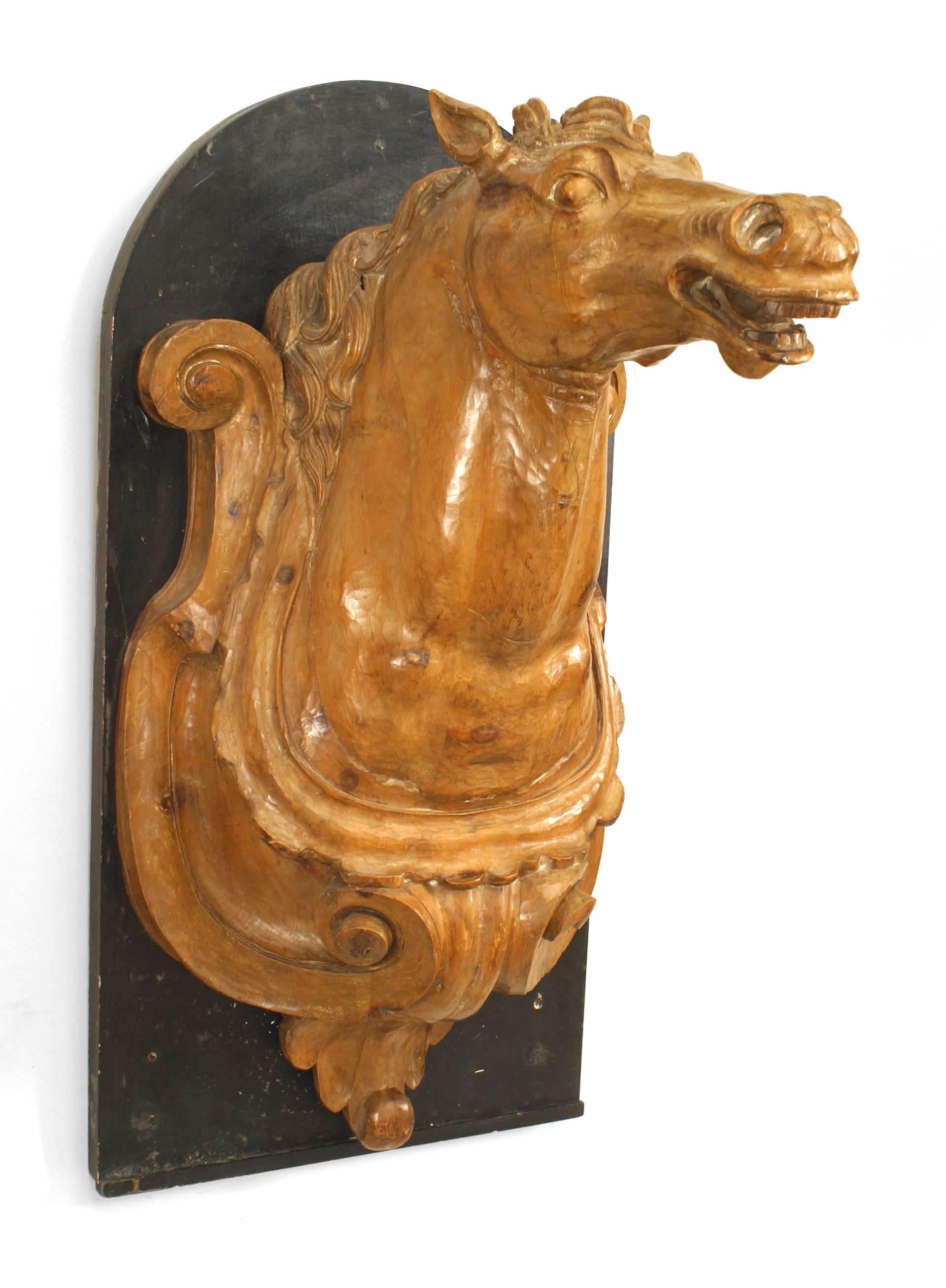 4 French Provincial (19th Century) carved pine life-size horse head wall plaques on black painted panel.(PRICED EACH)
